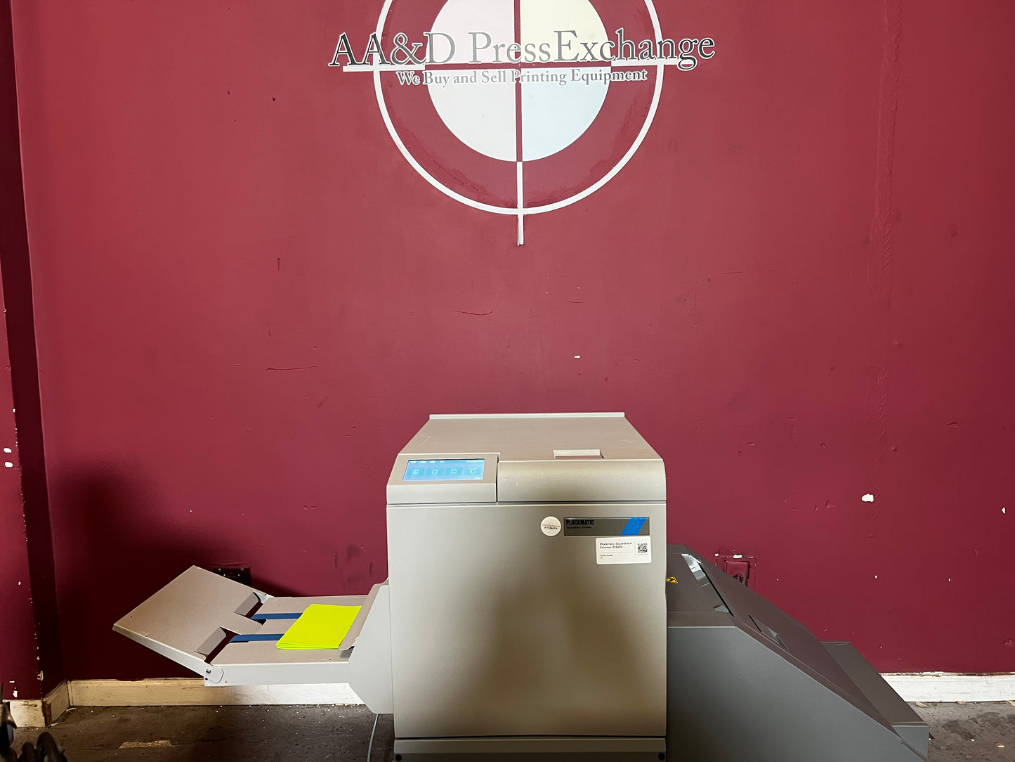Used Plockmatic SquareBack Trimmer angled view displaying booklet feeding tray – AA&D PressExchange