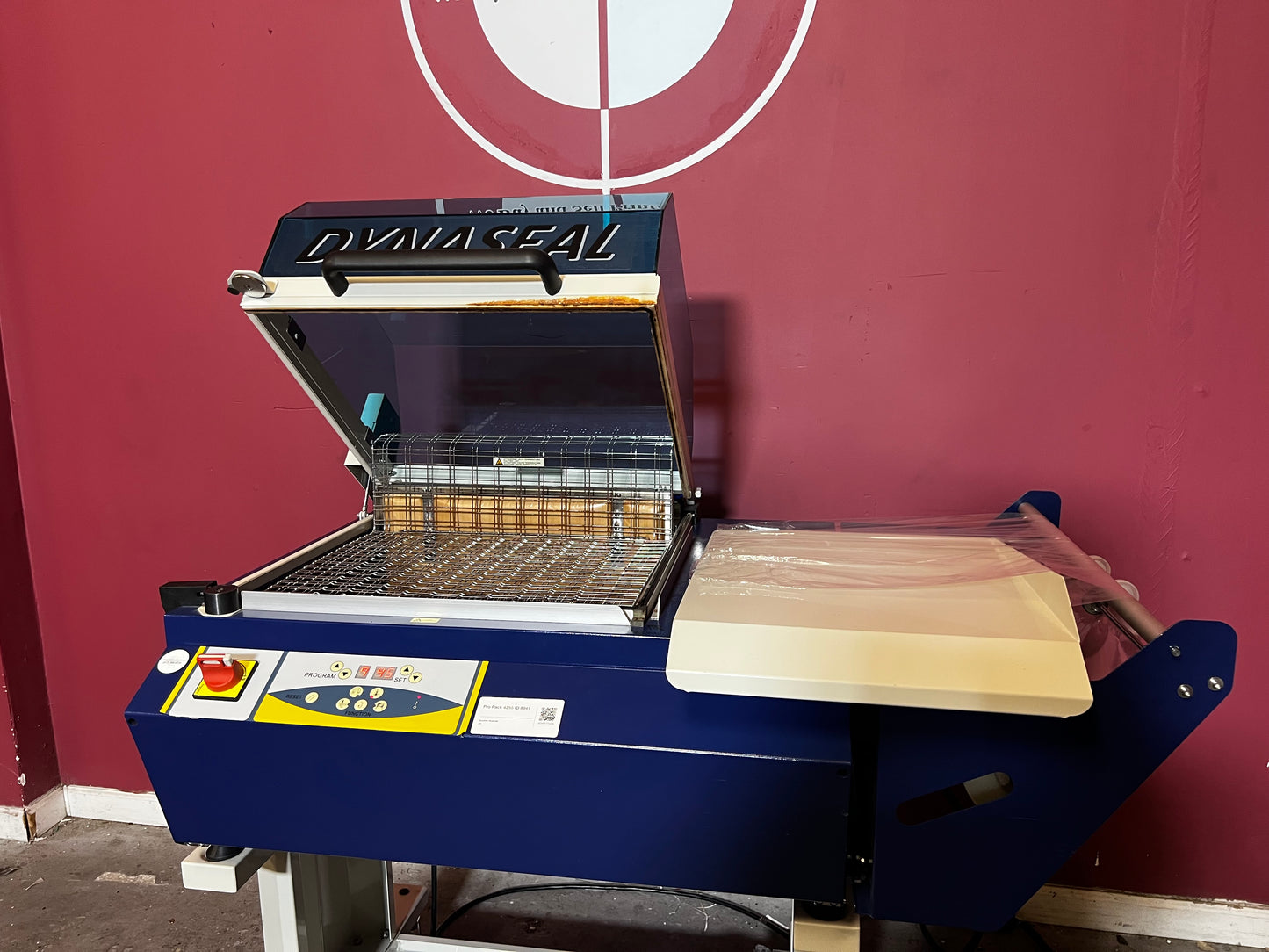 Used Dynaseal Shrink Wrapper detailed shot of film roll and feeding mechanism – AA&D PressExchange