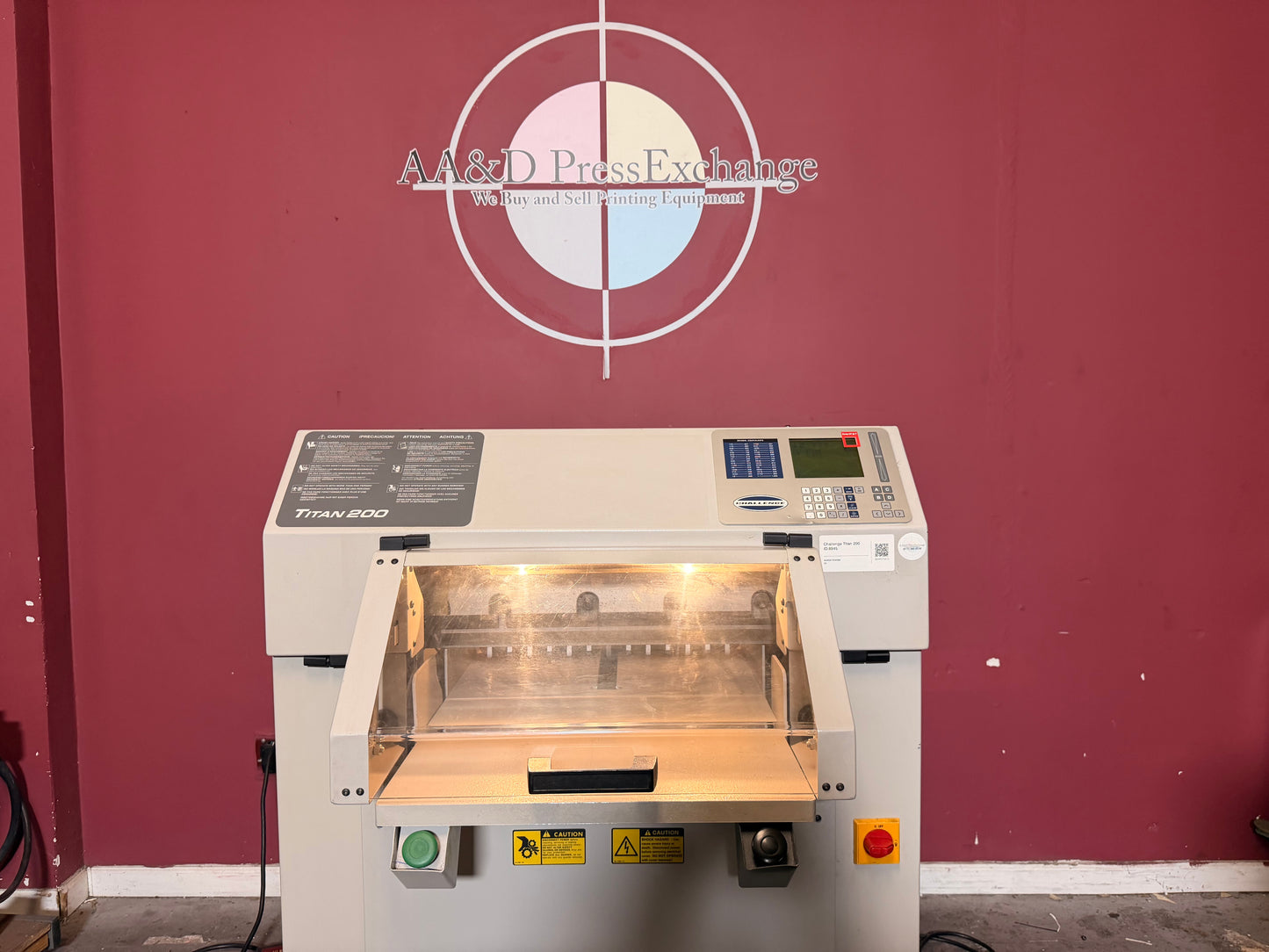 Used Challenge Titan 200 Hydraulic Paper Cutter by AA&D PressExchange, close-up of paper stack being clamped