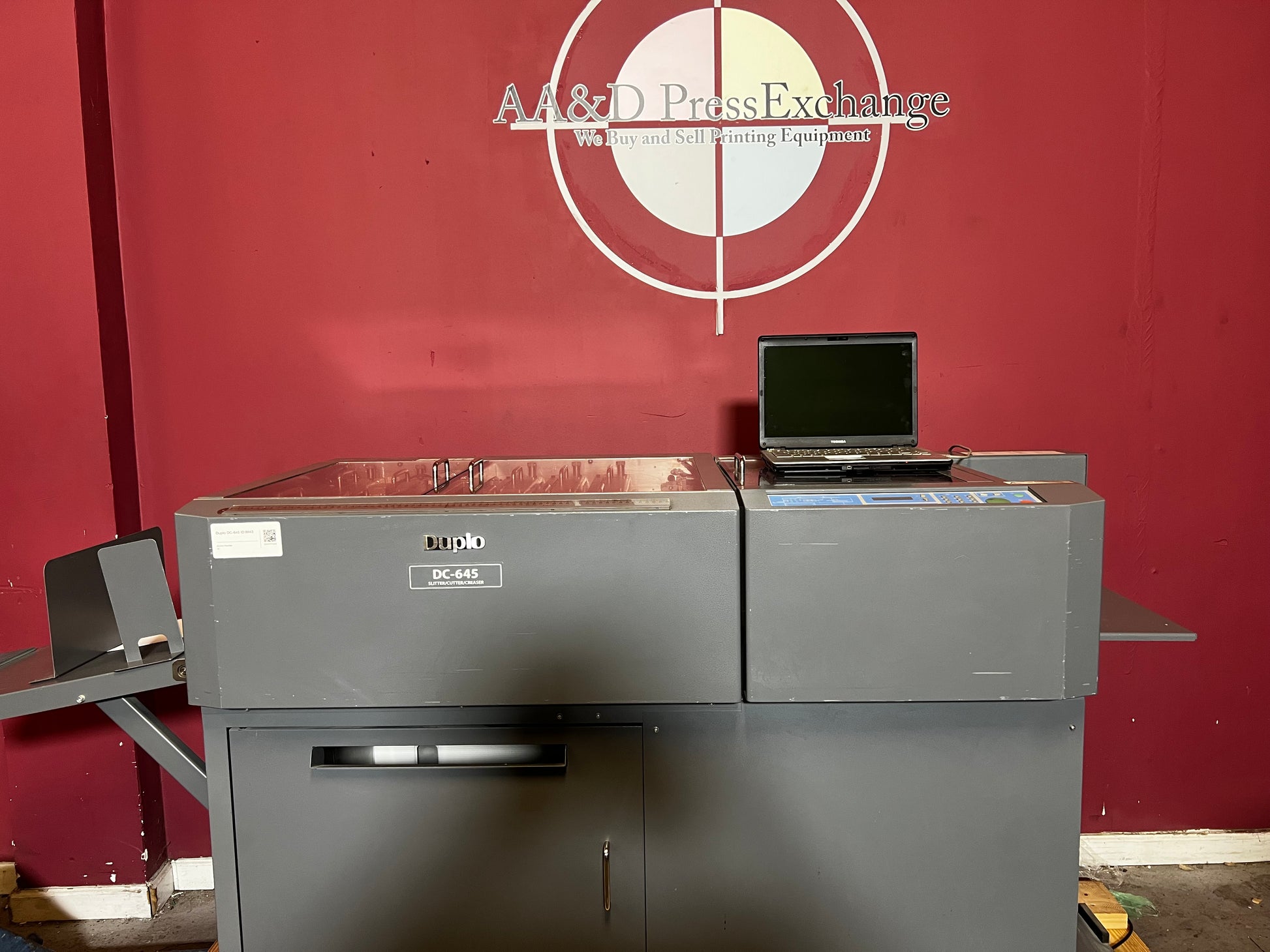 Used Duplo DC-645 Slitter Cutter Creaser side view showing automated feeder and finishing output – AA&D PressExchange