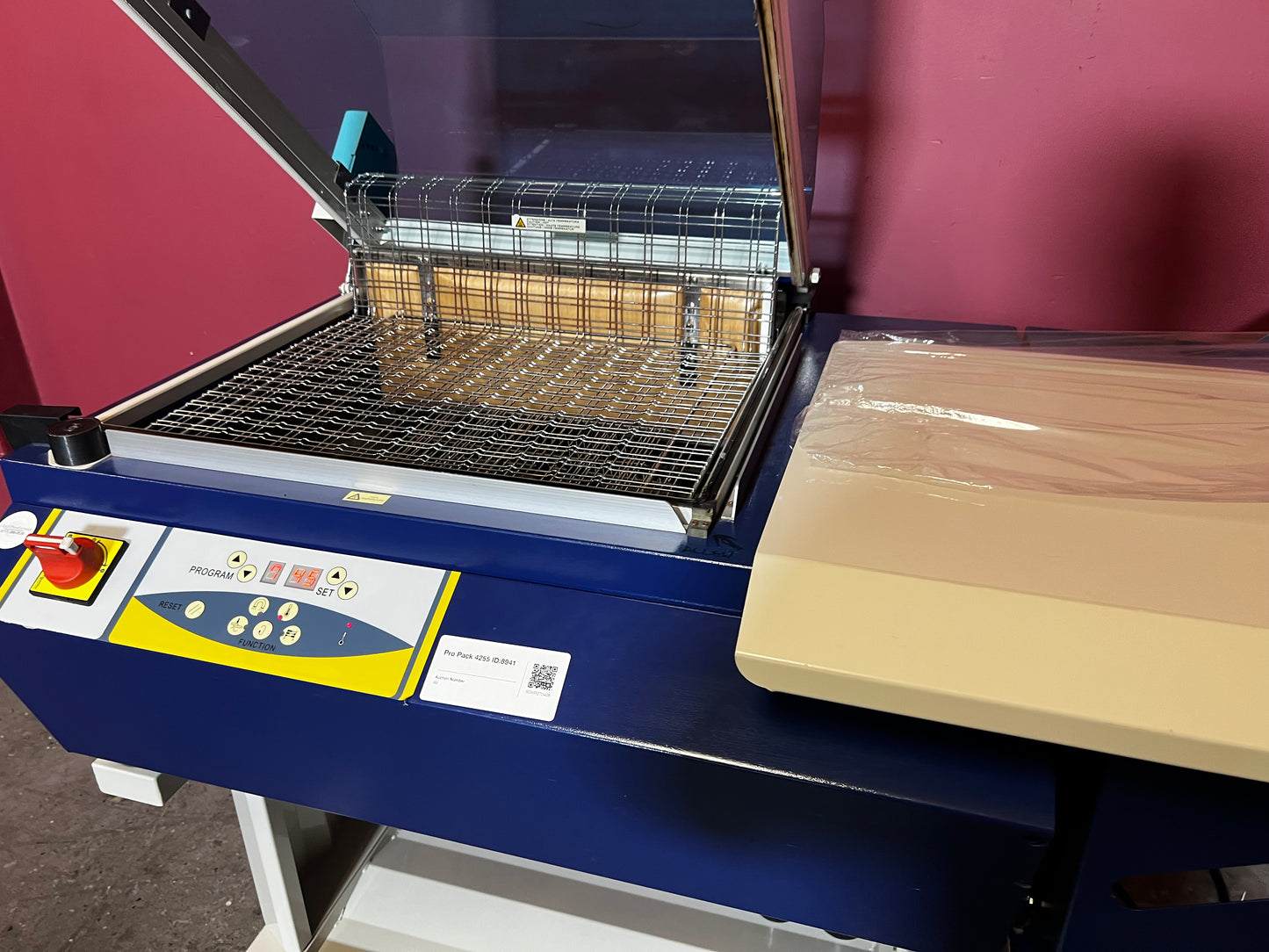 Used Dynaseal Shrink Wrapper close-up of shrink film feeding system – AA&D PressExchange