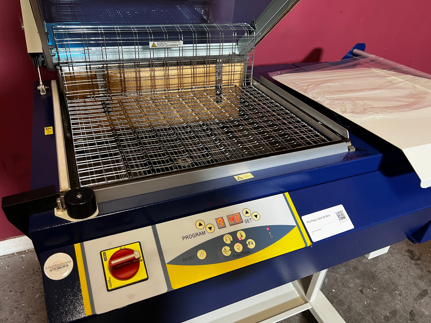 Used Dynaseal Shrink Wrapper angled view showing full machine setup – AA&D PressExchange