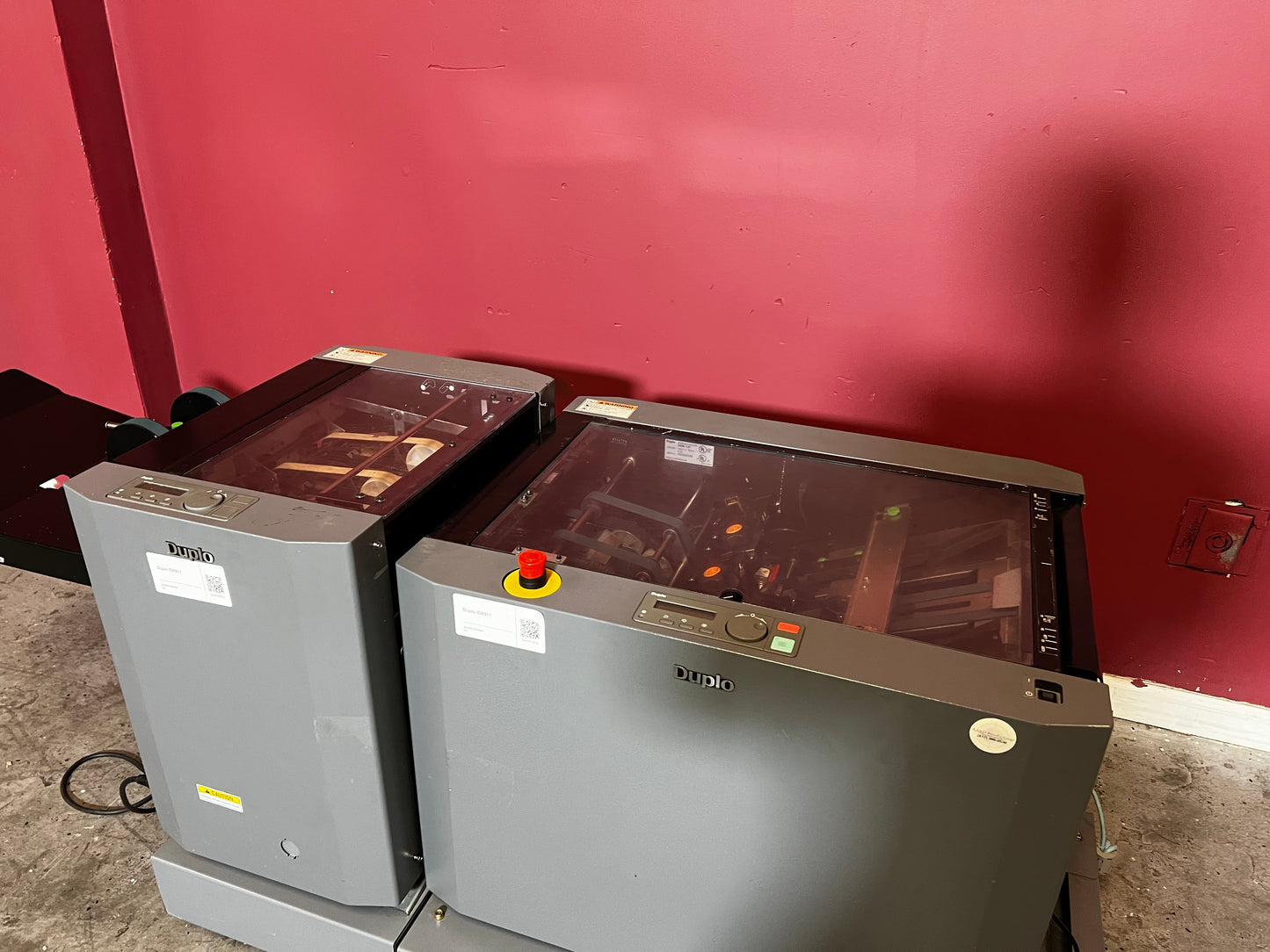 Used Duplo DBM-120 booklet maker with trimmer close-up of saddle-stitch and fold section – AA&D PressExchange
