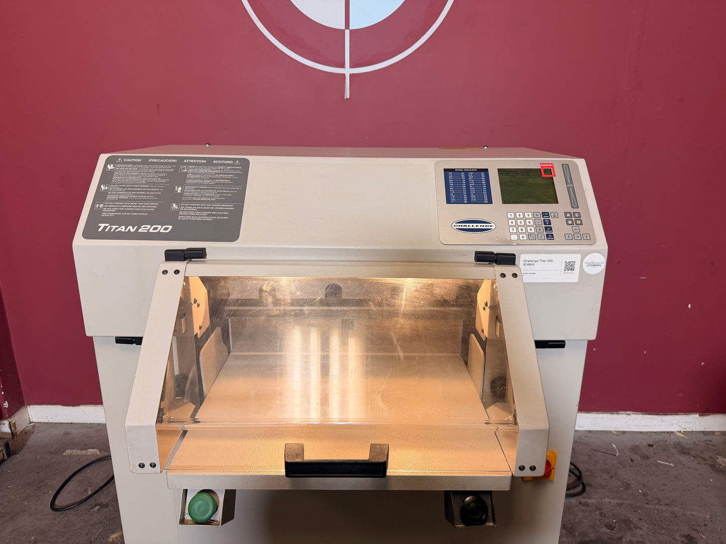 Used Challenge Titan 200 Hydraulic Paper Cutter by AA&D PressExchange, angle view of safety latch and tilt shield