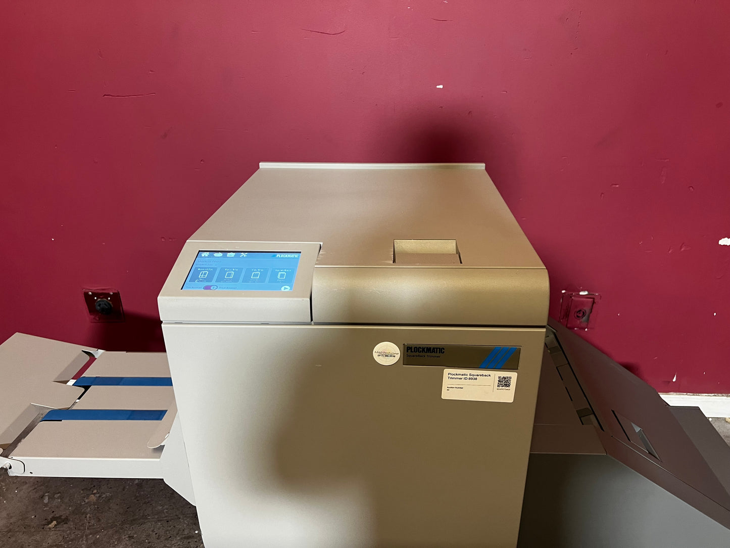 Used Plockmatic SquareBack Trimmer side view connected to booklet maker system – AA&D PressExchange