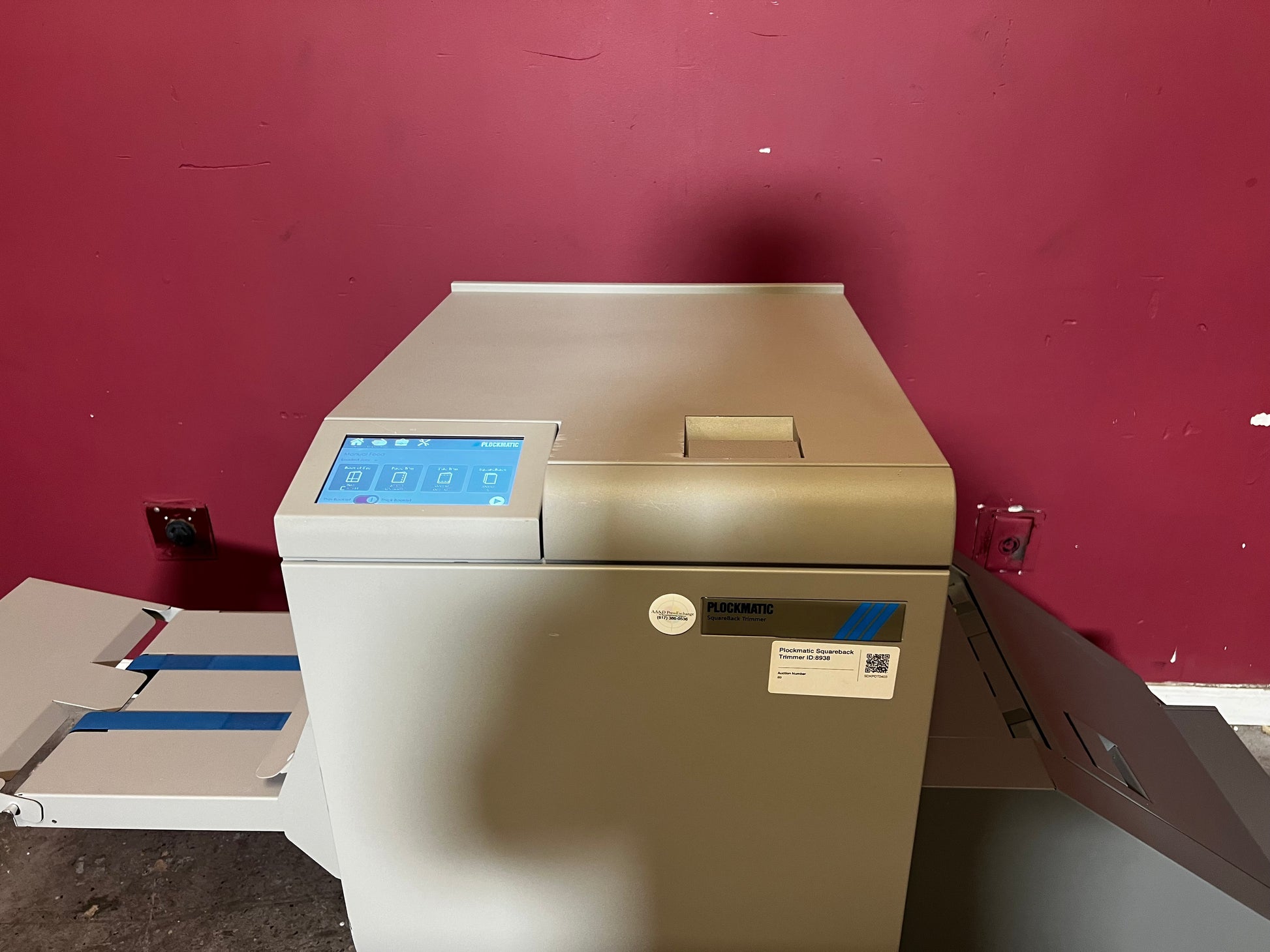 Used Plockmatic SquareBack Trimmer side view connected to booklet maker system – AA&D PressExchange