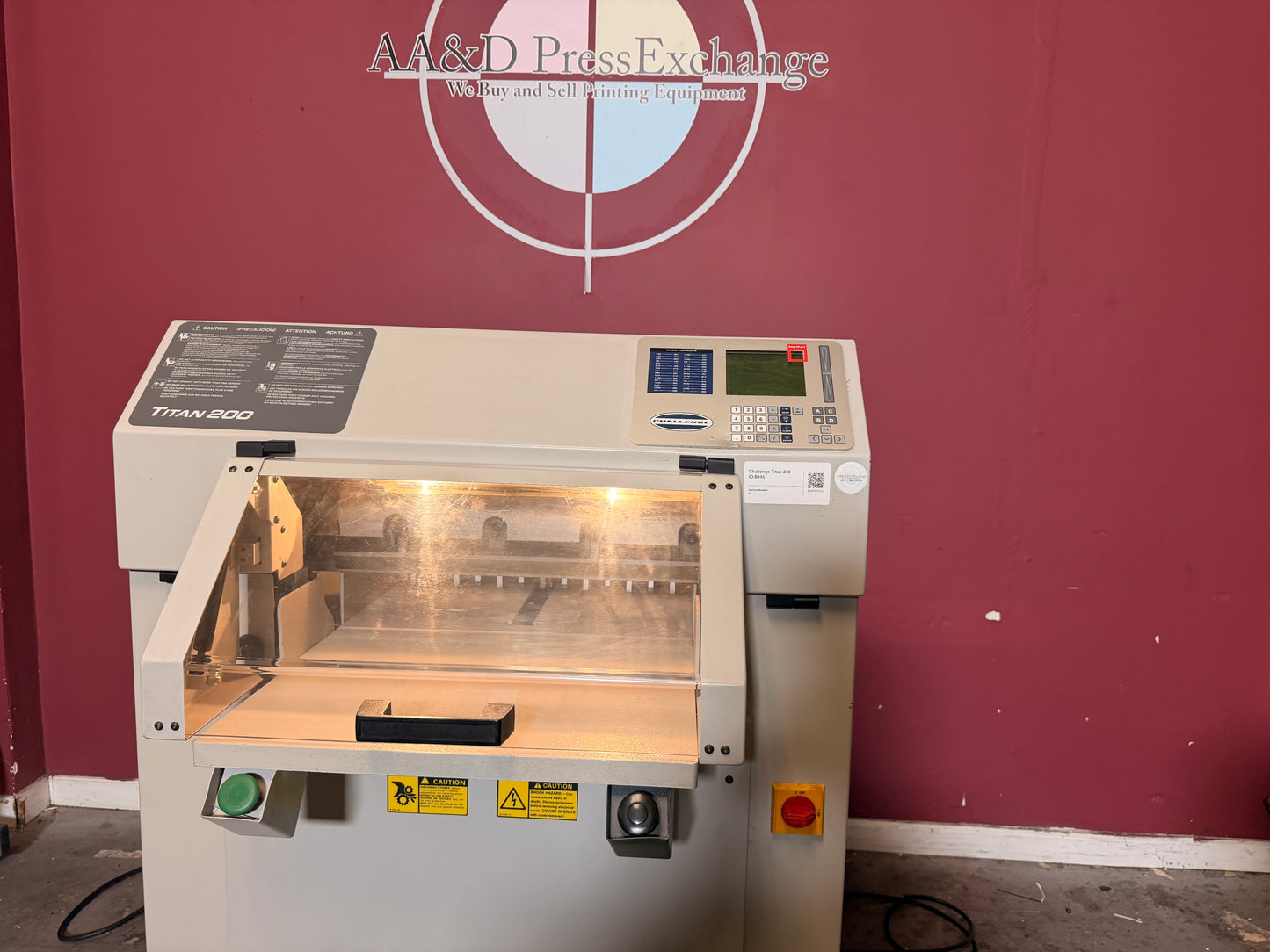 Used Challenge Titan 200 Hydraulic Paper Cutter by AA&D PressExchange, operational view showing large stack cutting