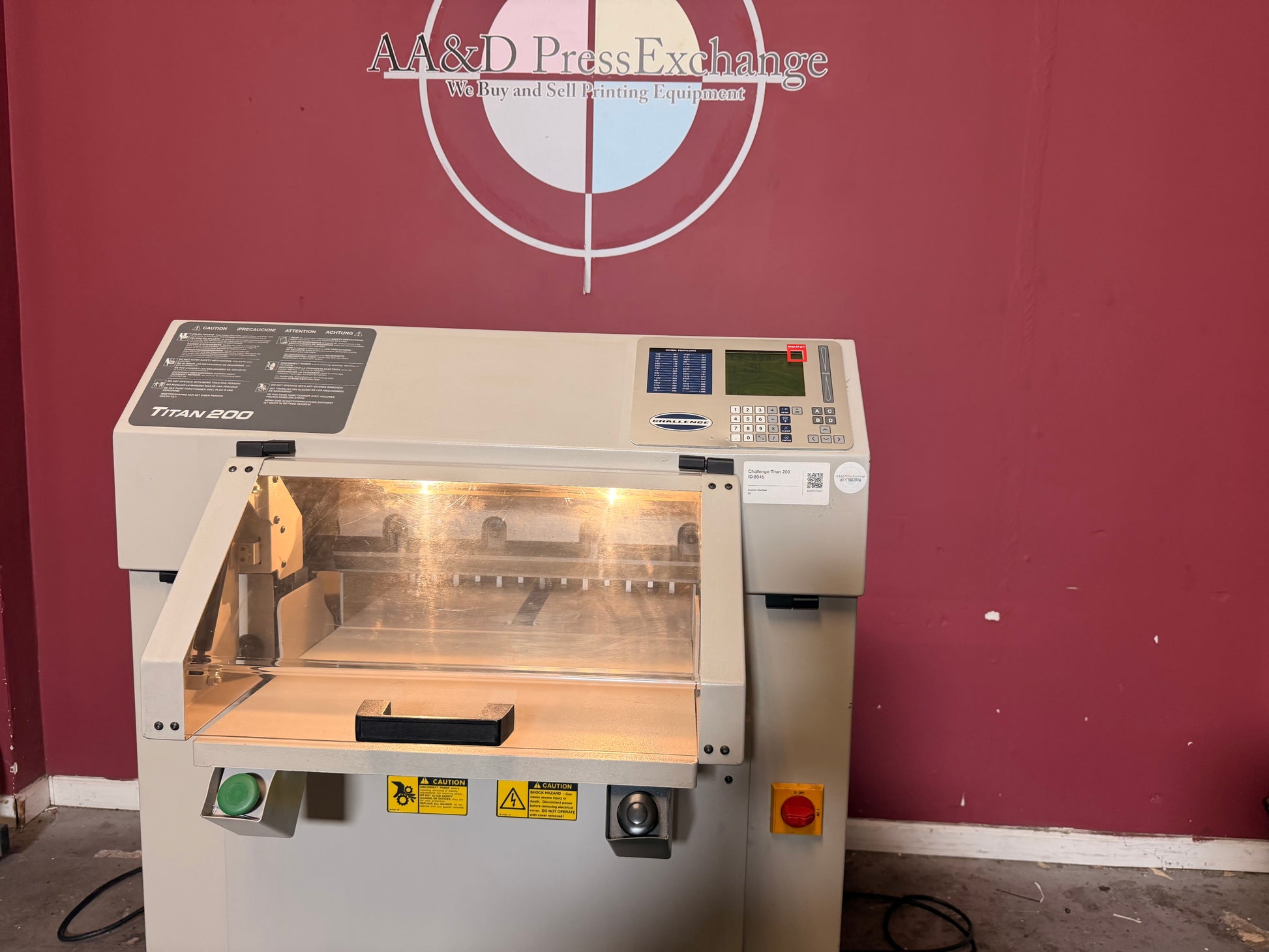 Used Challenge Titan 200 Hydraulic Paper Cutter by AA&D PressExchange, operational view showing large stack cutting