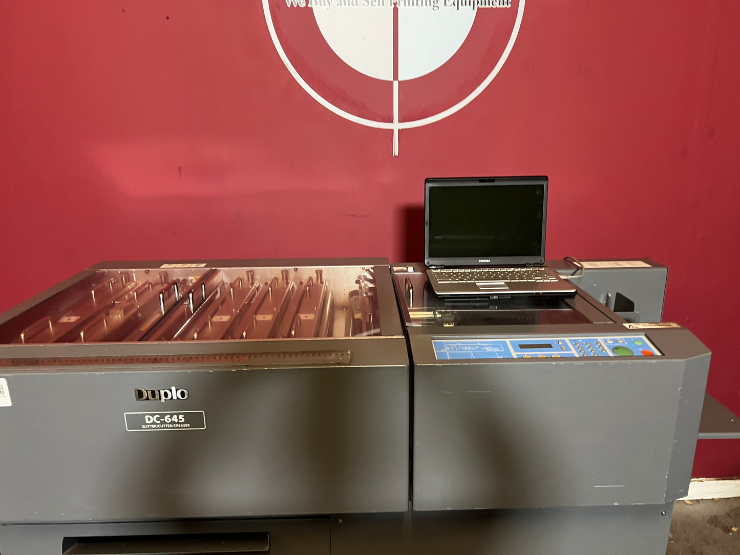 Used Duplo DC-645 Slitter Cutter Creaser side view showing paper exit and stacker – AA&D PressExchange