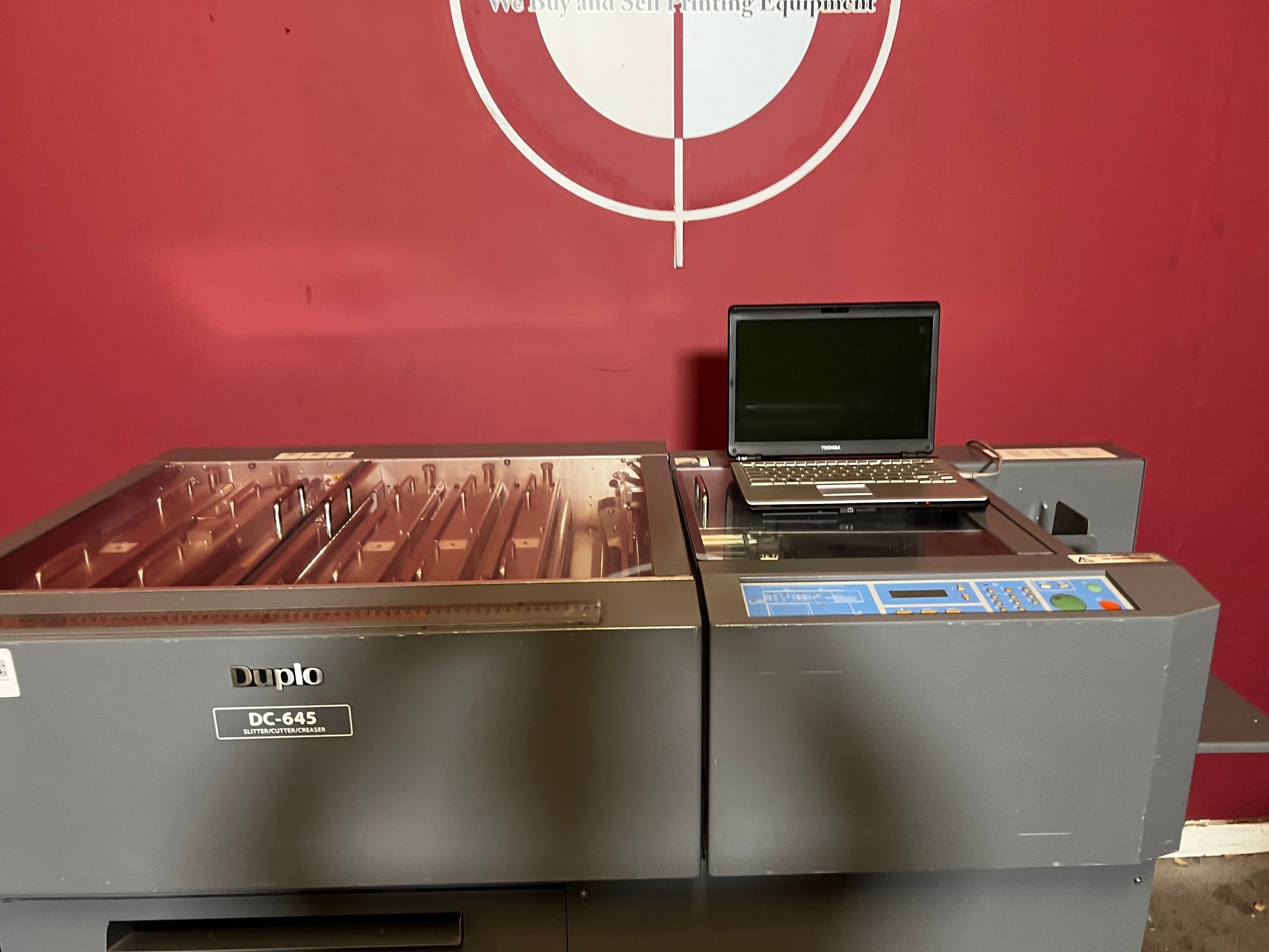 Used Duplo DC-645 Slitter Cutter Creaser side view showing paper exit and stacker – AA&D PressExchange