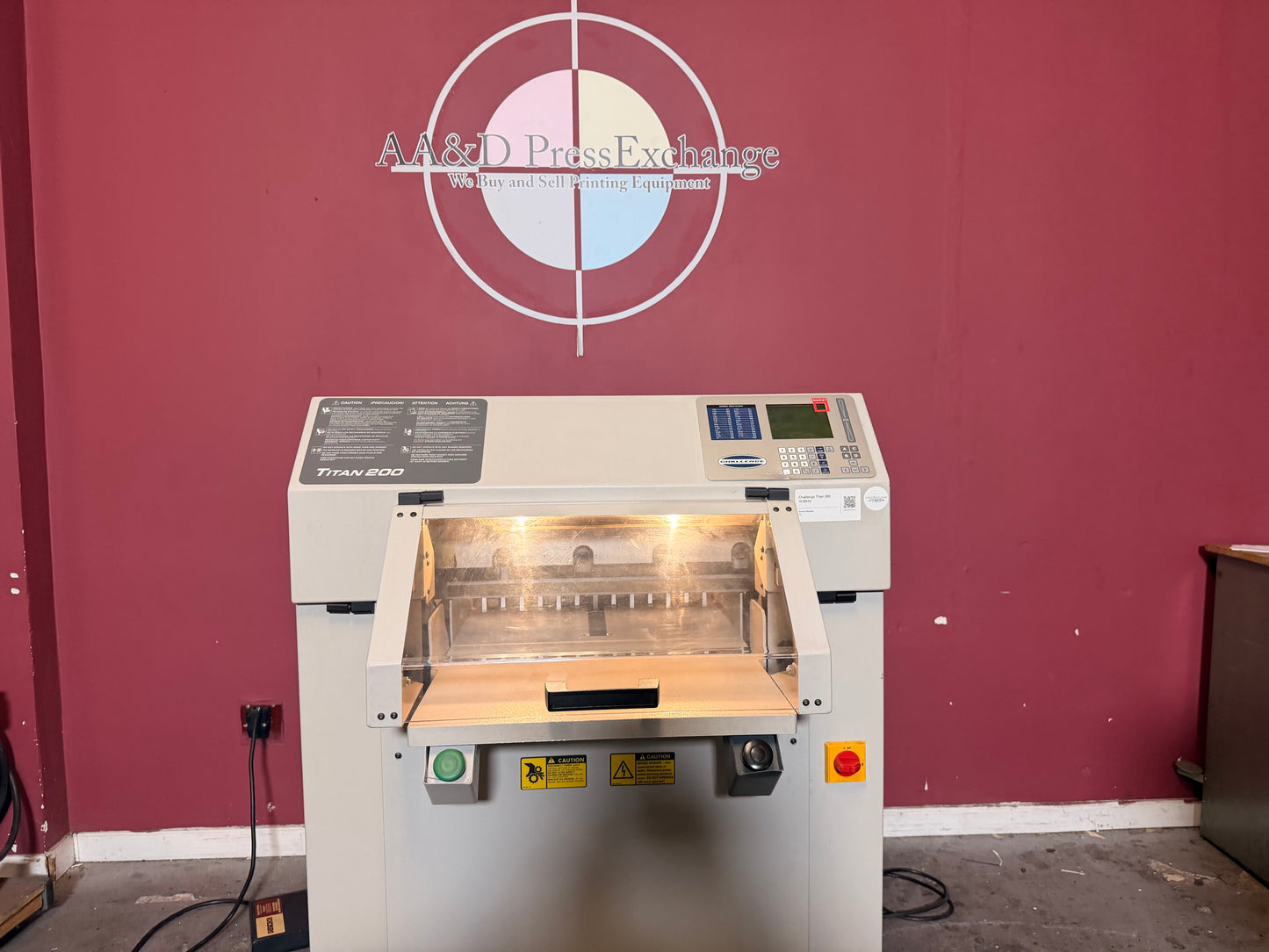 Used Challenge Titan 200 Hydraulic Paper Cutter by AA&D PressExchange, operational view with stack of paper