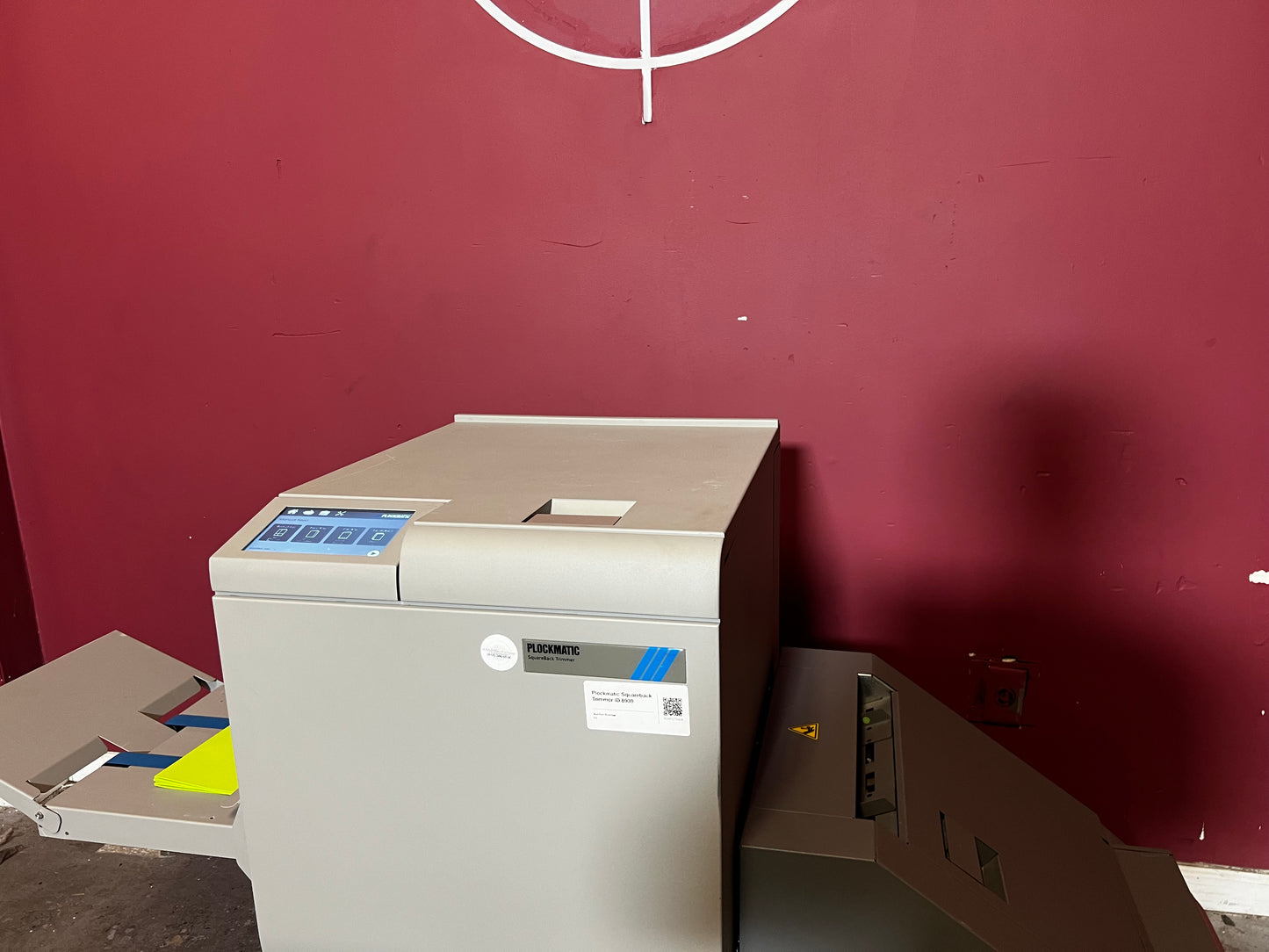 Used Plockmatic SquareBack Trimmer close-up of book output section and trim collection bin – AA&D PressExchange