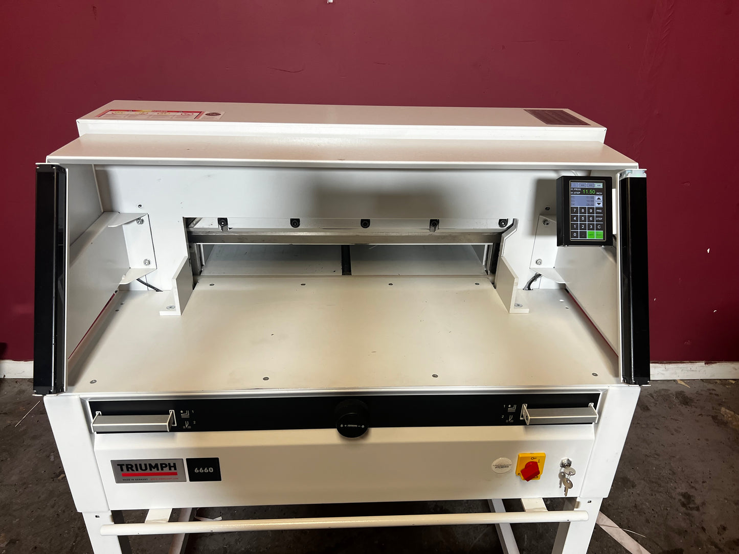 Used Triumph 6660 paper cutter angled rear view of guillotine unit – AA&D PressExchange