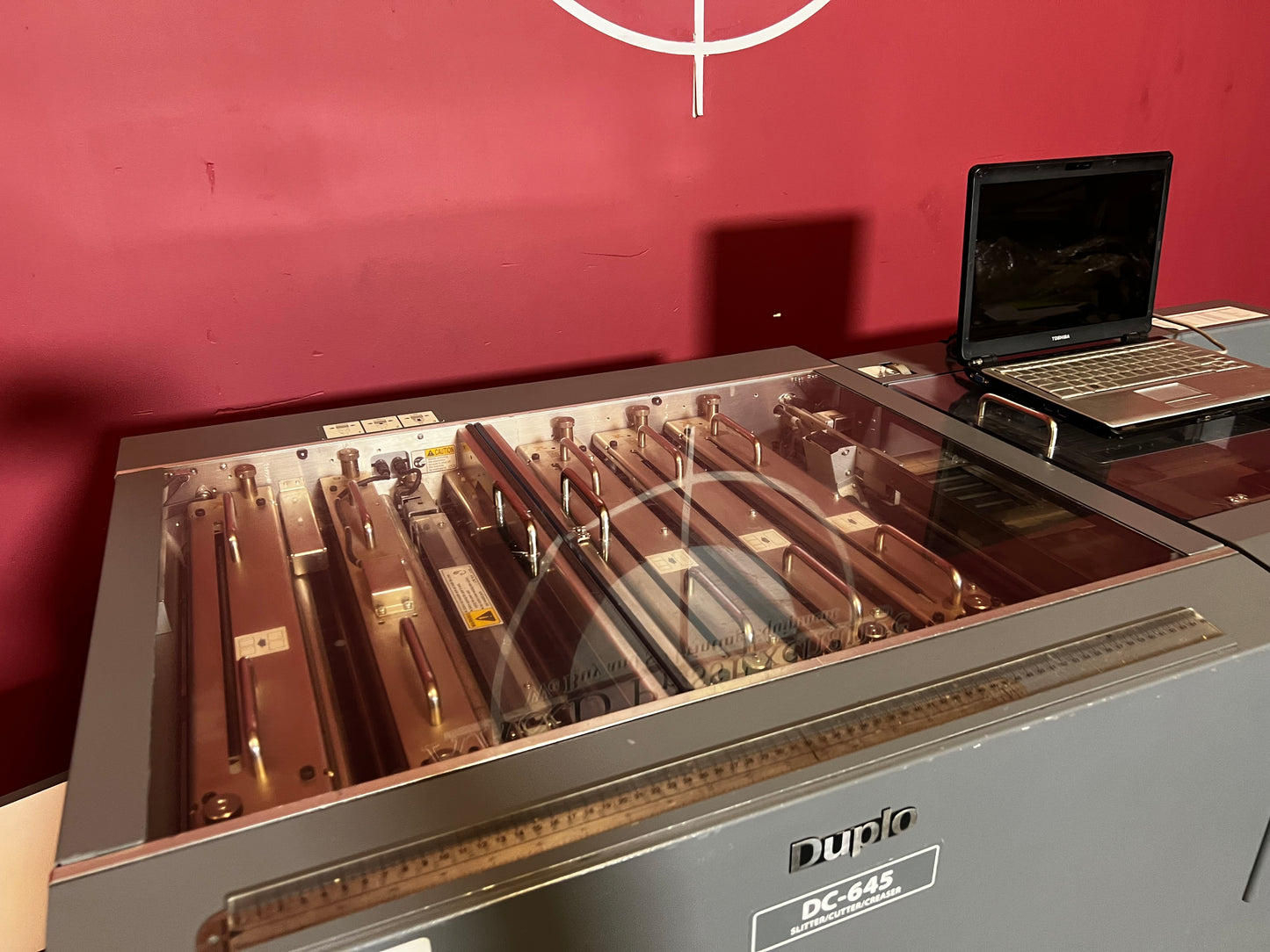 Used Duplo DC-645 Slitter Cutter Creaser close-up of feeder and barcode reader – AA&D PressExchange