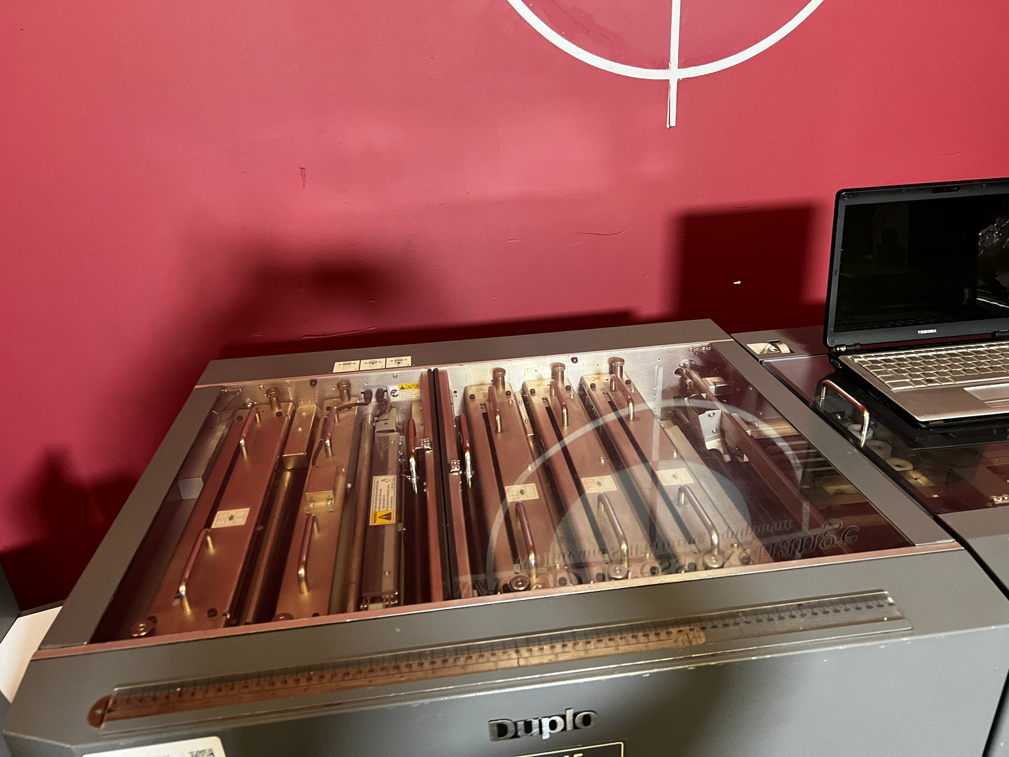 Used Duplo DC-645 Slitter Cutter Creaser side view showing paper feed and guides – AA&D PressExchange