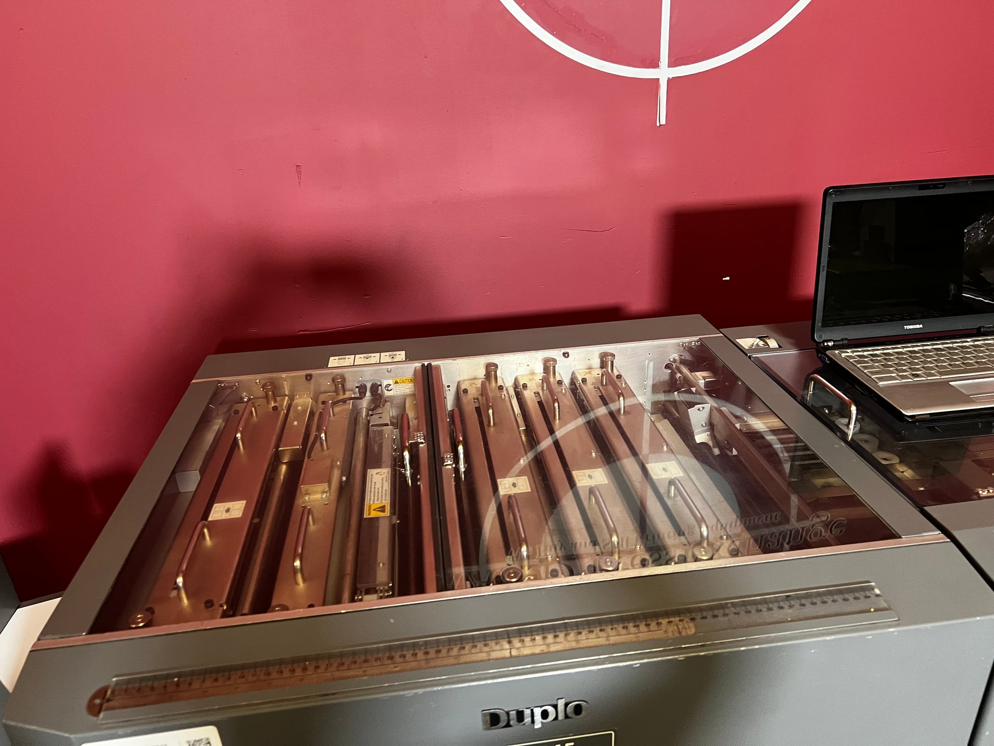 Used Duplo DC-645 Slitter Cutter Creaser side view showing paper feed and guides – AA&D PressExchange