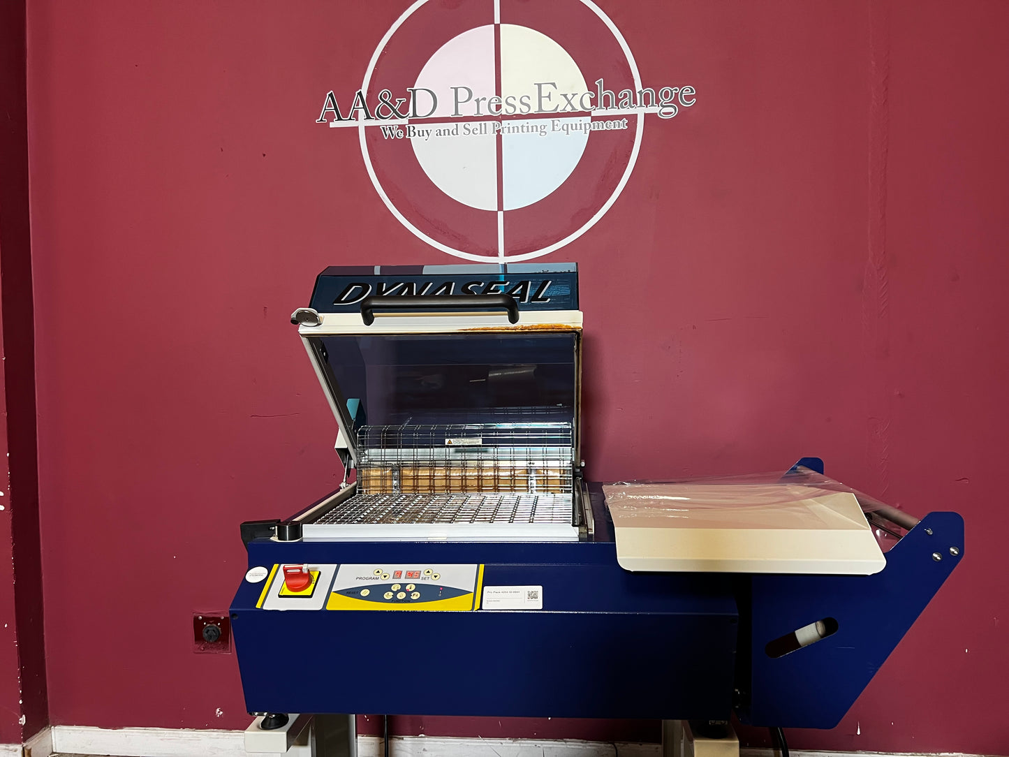 Used Dynaseal Shrink Wrapper side view showing automated sealing in action – AA&D PressExchange