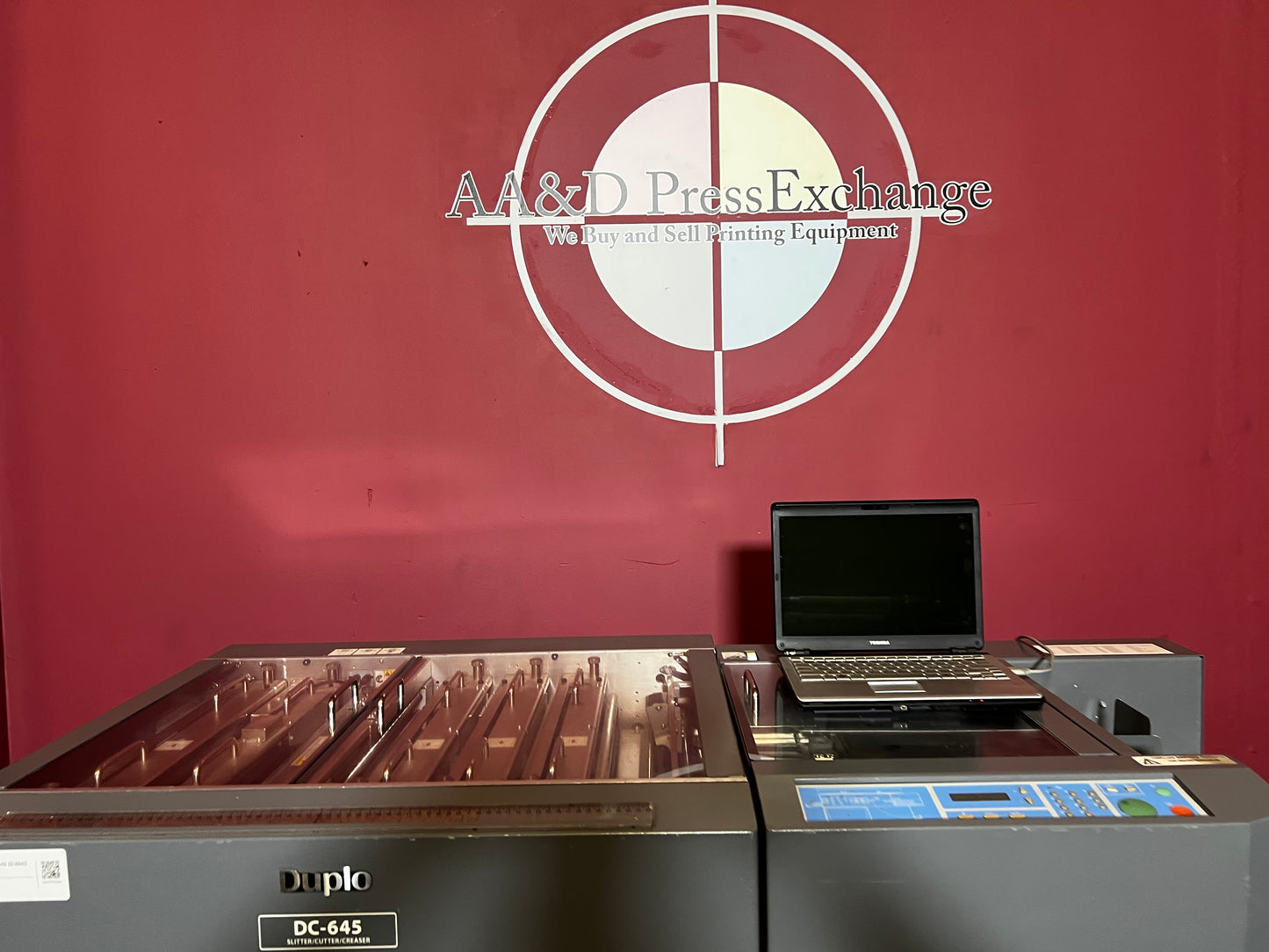 Used Duplo DC-645 Slitter Cutter Creaser angled view showing full machine setup – AA&D PressExchange