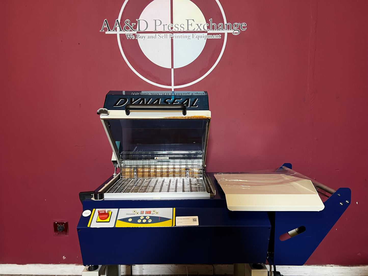 Used Dynaseal Shrink Wrapper close-up of machine conveyor and guides – AA&D PressExchange