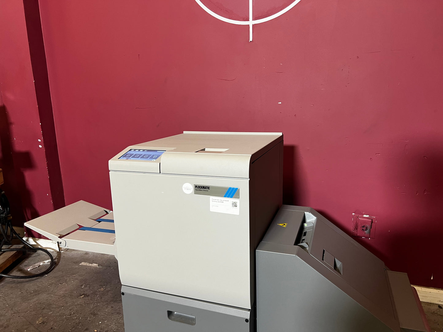 Used Plockmatic SquareBack Trimmer detailed image showing booklet alignment and trimming process – AA&D PressExchange