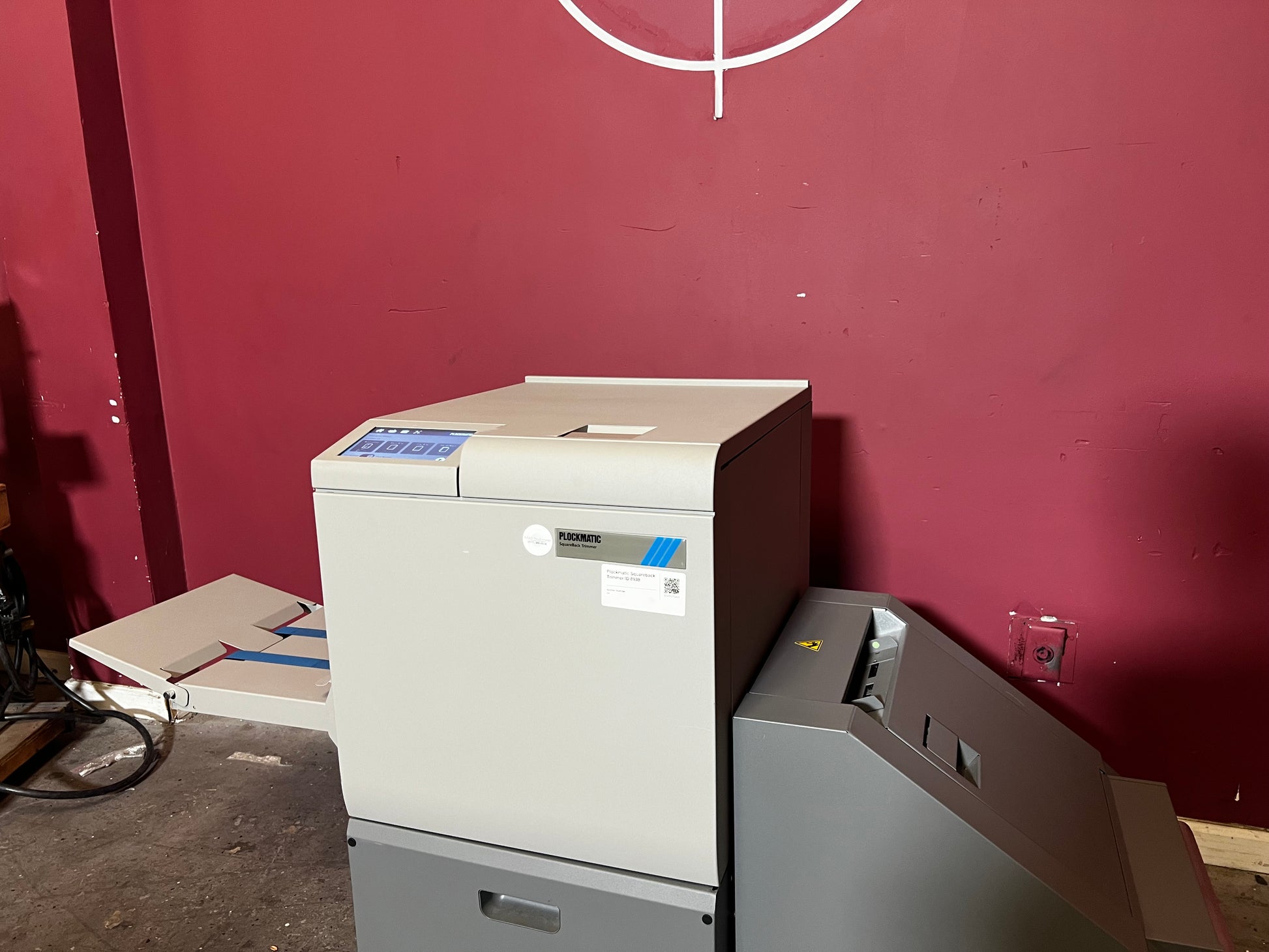 Used Plockmatic SquareBack Trimmer detailed image showing booklet alignment and trimming process – AA&D PressExchange
