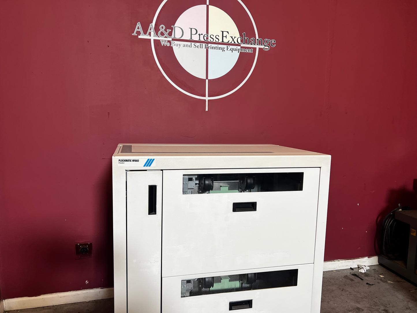 Used Plockmatic VF602 vacuum feeder side view connected to booklet maker for continuous production – AA&D PressExchange