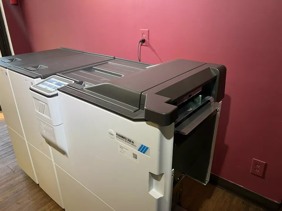 Used Plockmatic 350-m LOW METER 125K booklet maker showing saddle-stitch mechanism and control panel – AA&D PressExchange