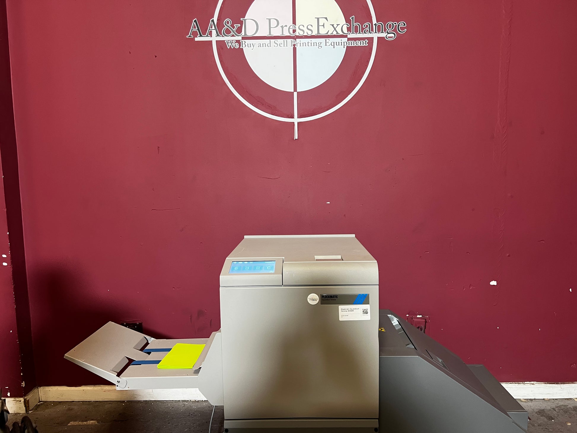 Used Plockmatic SquareBack Trimmer angled view displaying booklet feeding tray – AA&D PressExchange