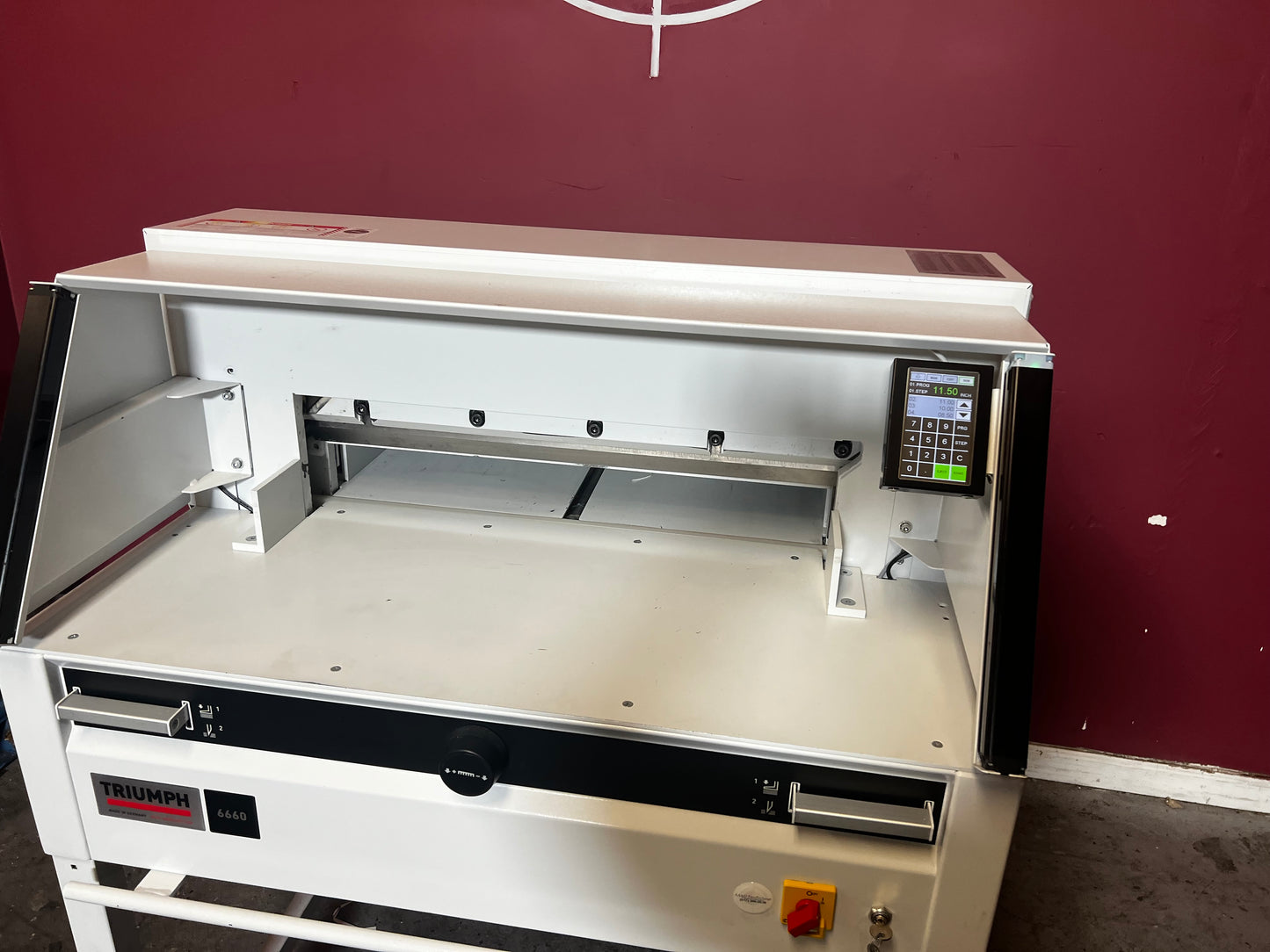 Used Triumph 6660 paper cutter front/side view showing safety cover and paper guide – AA&D PressExchange