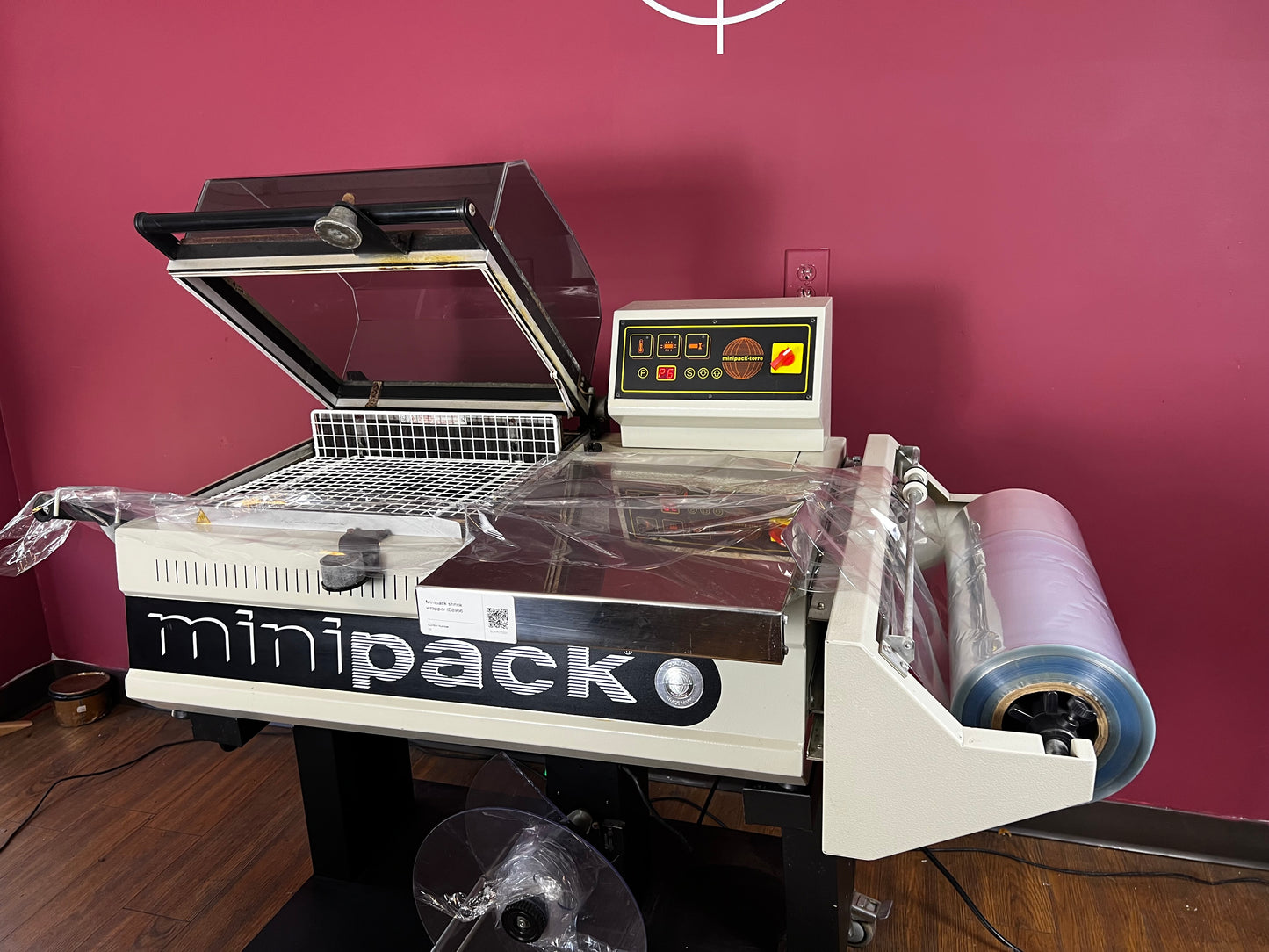 Used Minipack FM-75 Digit shrink wrap machine with hood open | AA&D PressExchange