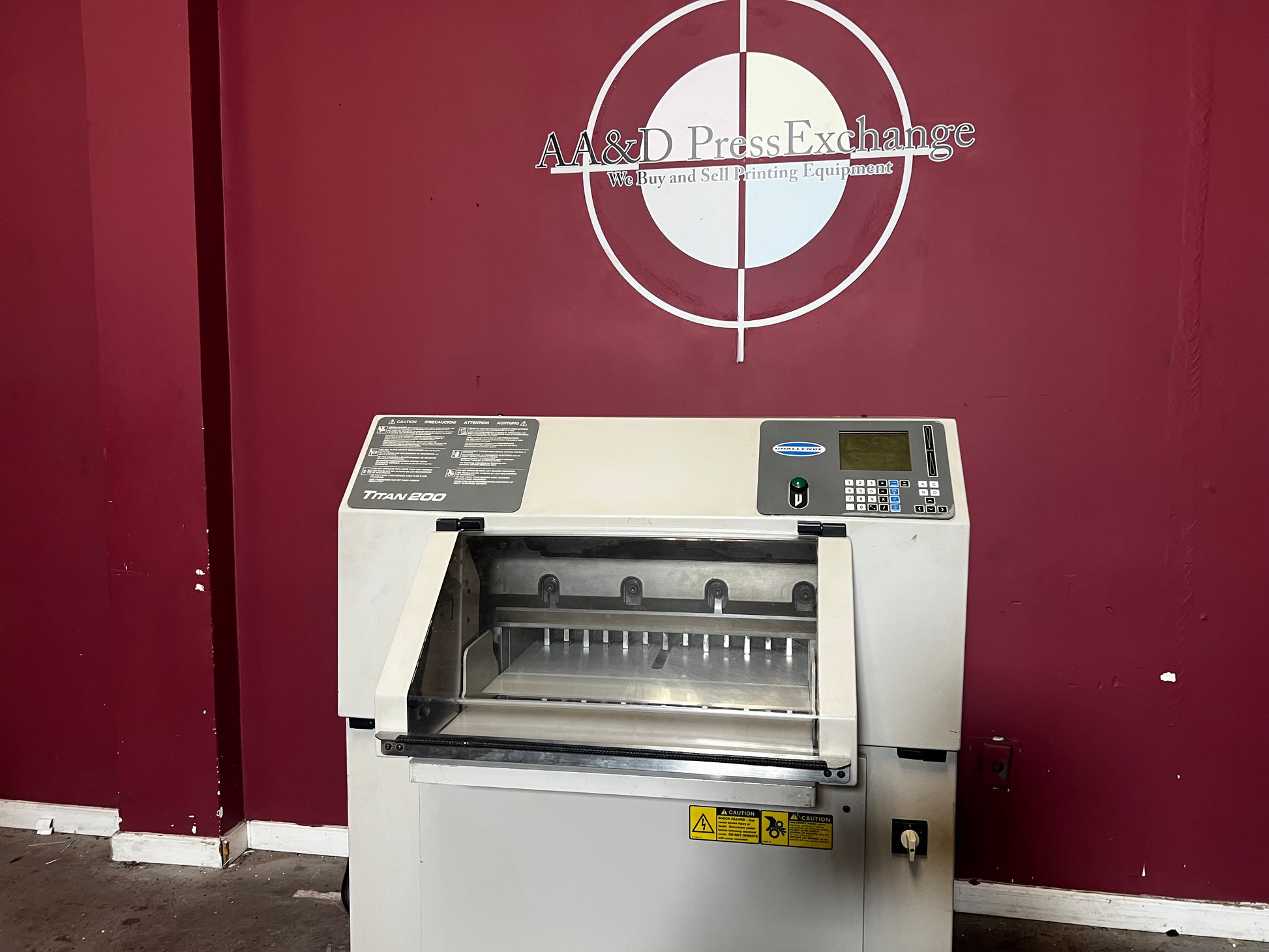 AA&D PressExchange used Challenge Titan 200 Hydraulic Paper Cutter showing 20-inch cutting width.