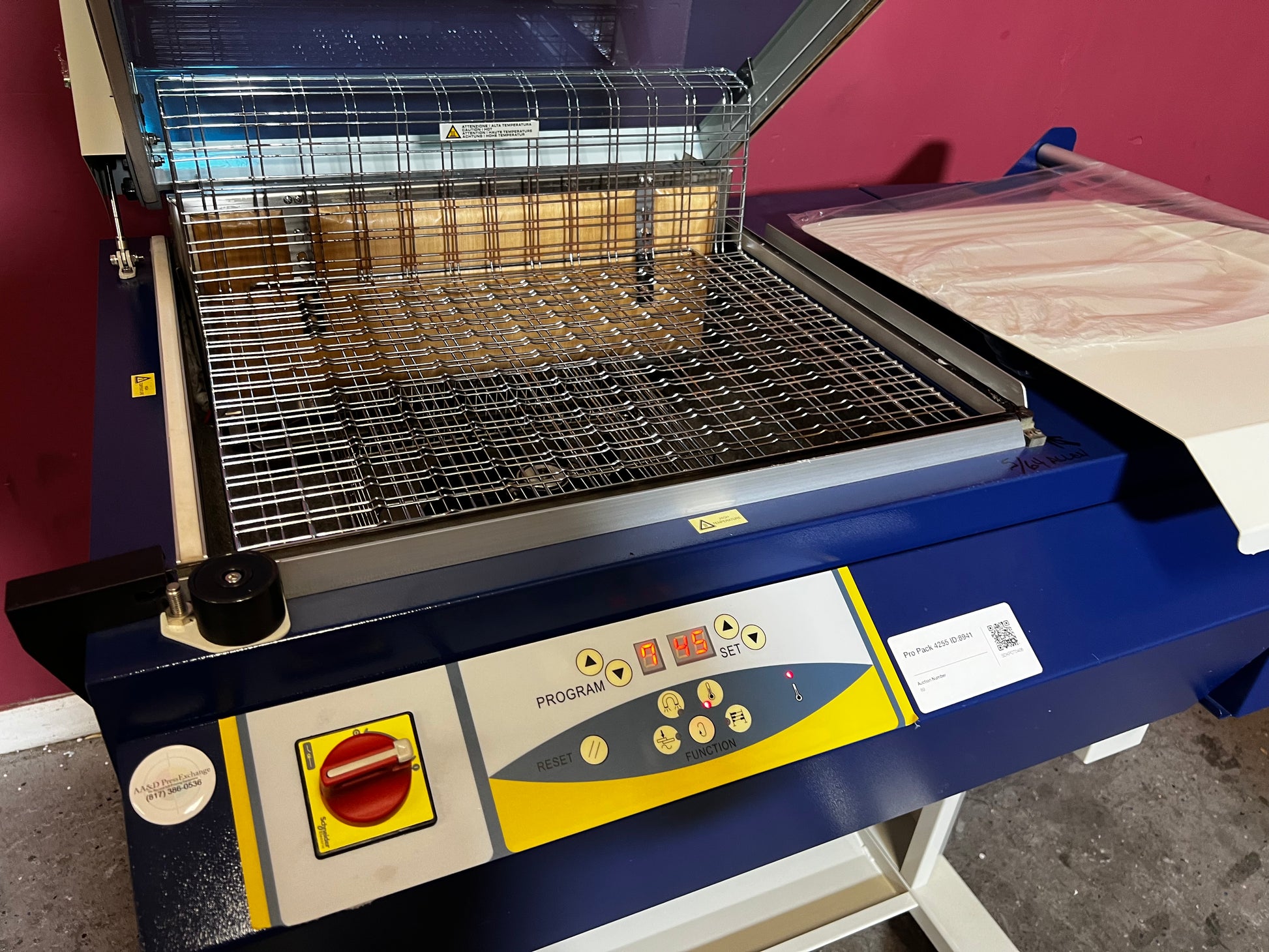 Used Dynaseal Shrink Wrapper angled view showing full machine setup – AA&D PressExchange