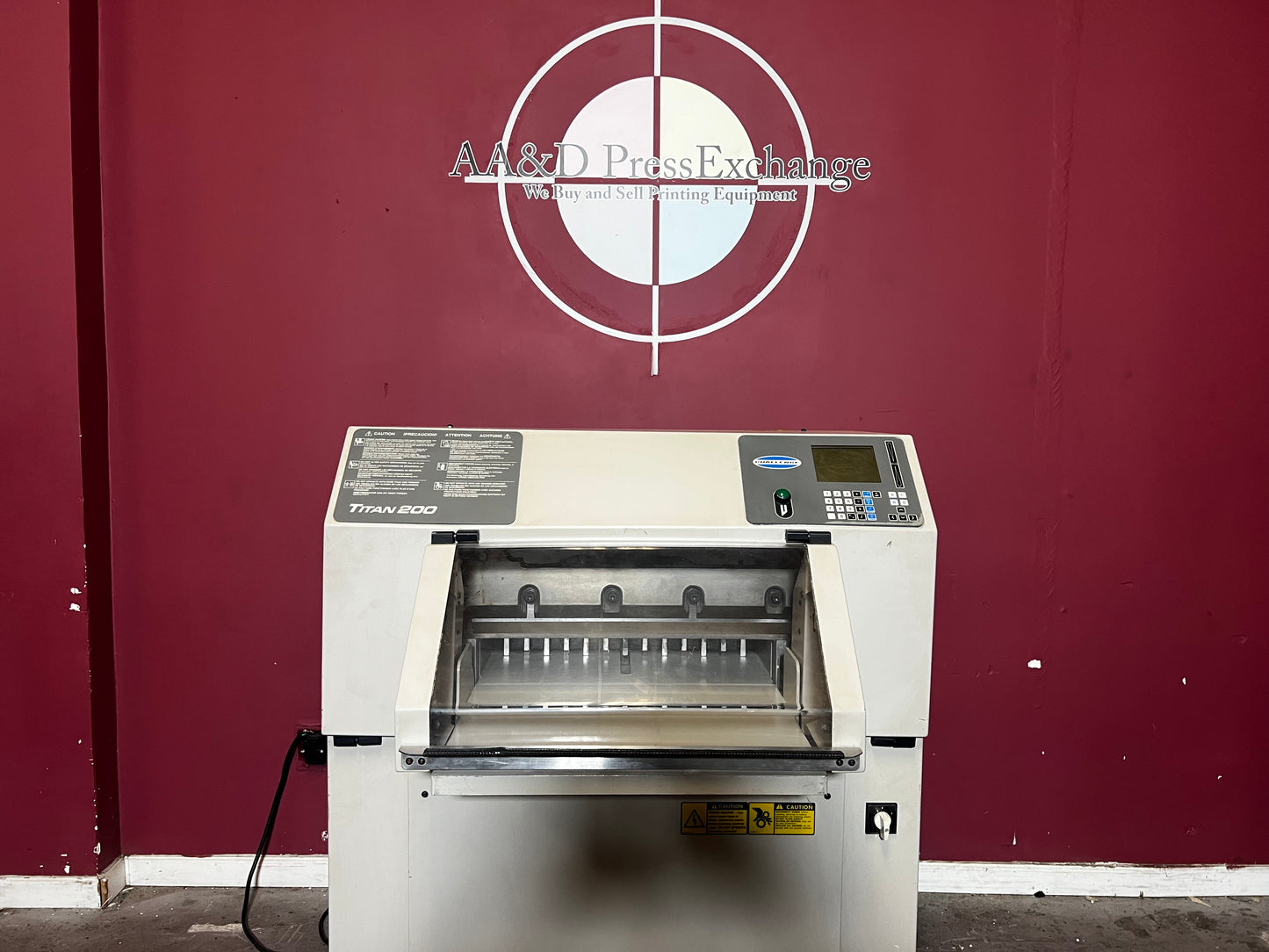 Used Challenge Titan 200 Hydraulic Paper Cutter at AA&D PressExchange, front view with safety features.