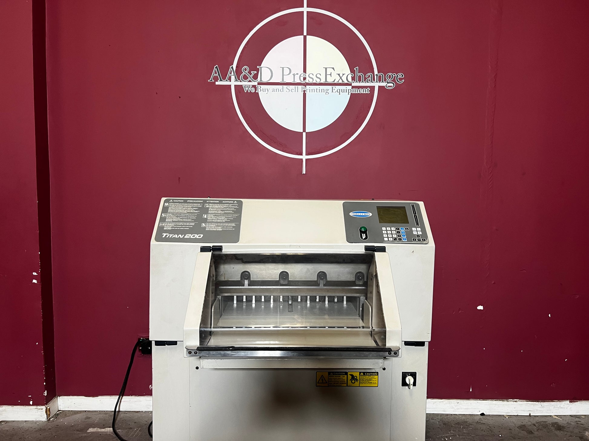 Used Challenge Titan 200 Hydraulic Paper Cutter at AA&D PressExchange, front view with safety features.