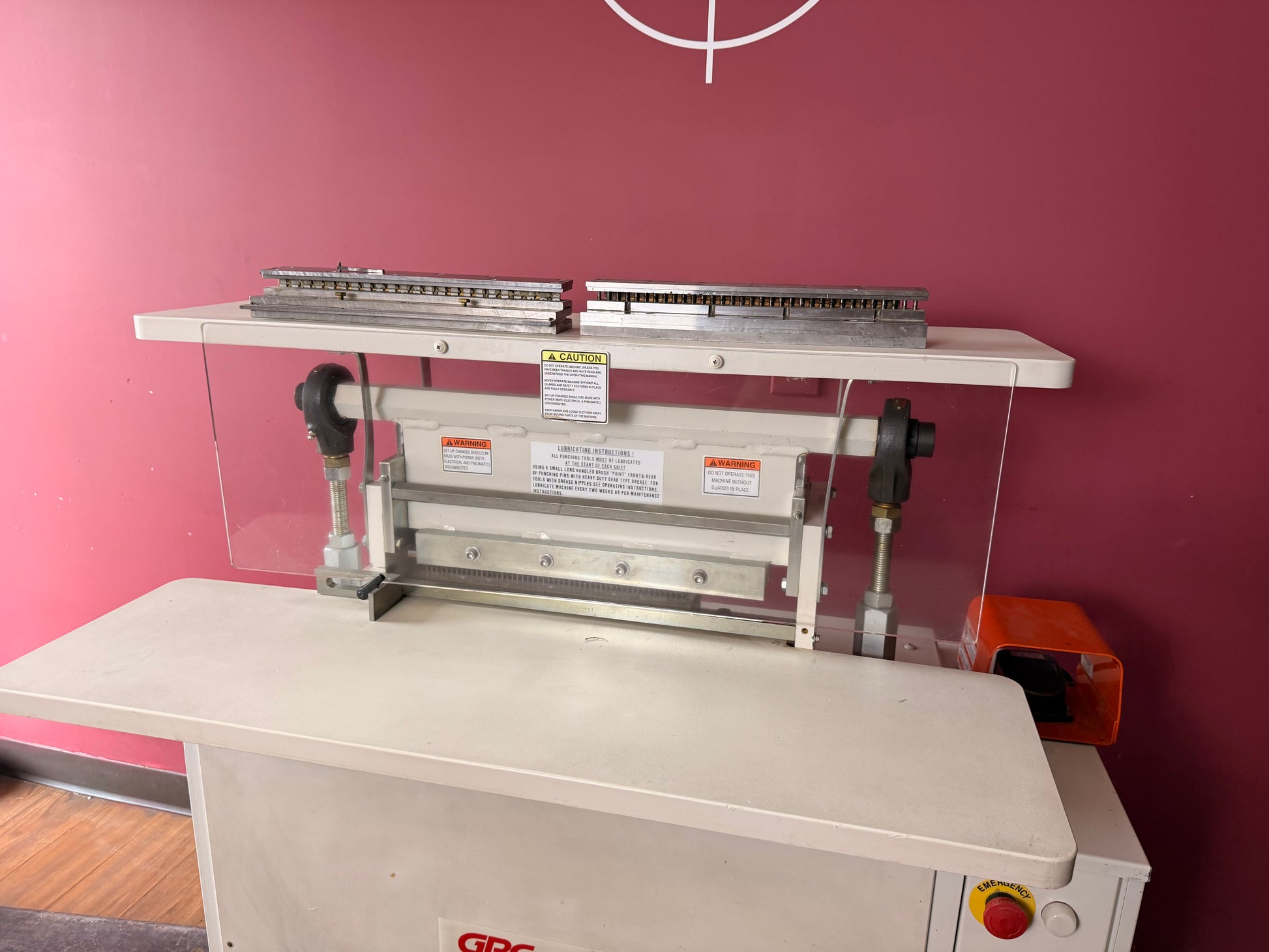 Top view of used GBC Sickinger MHP 17 paper punch with paper guides and die mechanism visible