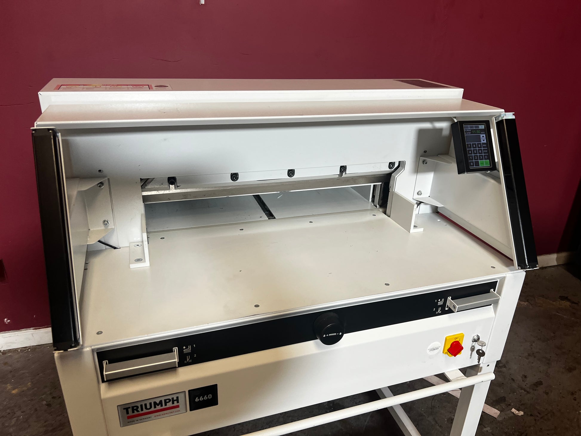 Used Triumph 6660 paper cutter close-up of clamp mechanism and blade – AA&D PressExchange