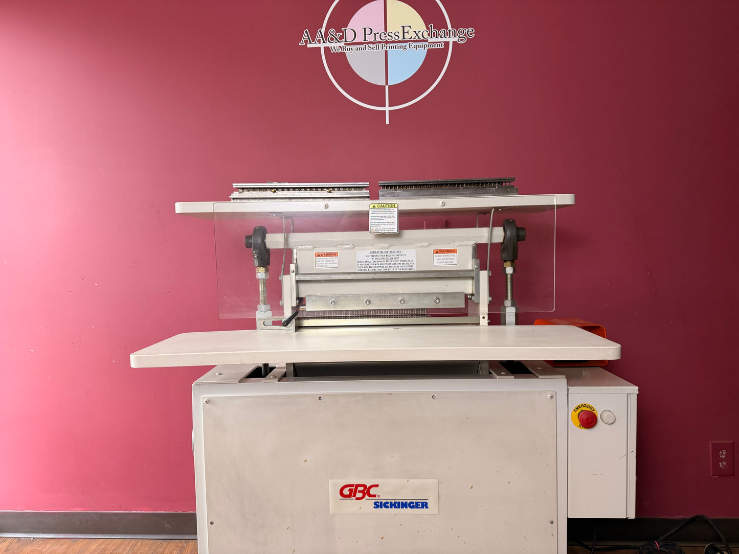 Overhead view of used GBC Sickinger MHP 17 paper punch showing punching area and die