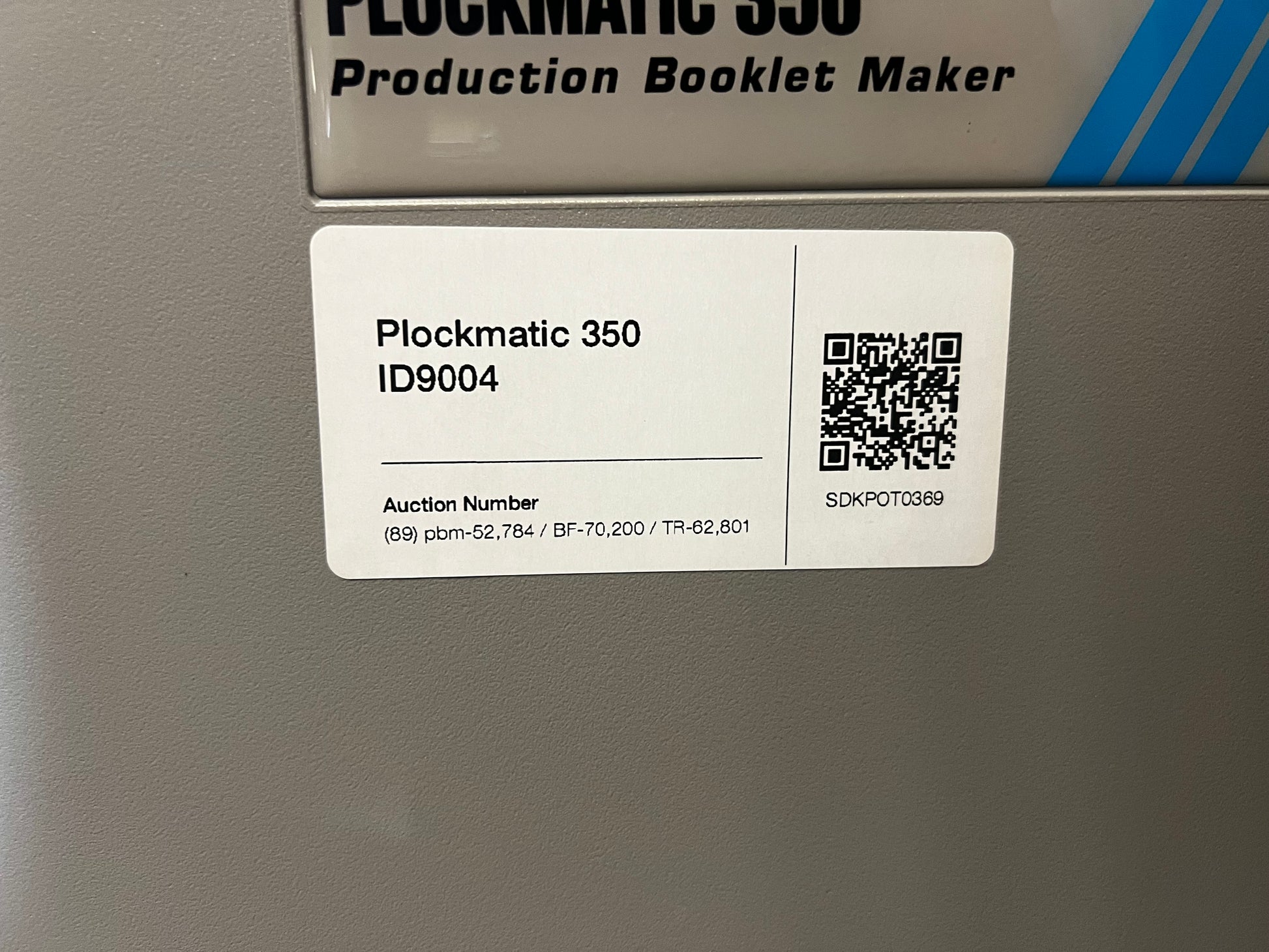 Used Plockmatic 350 70k meter booklet maker close-up of square back trimming operation – AA&D PressExchange
