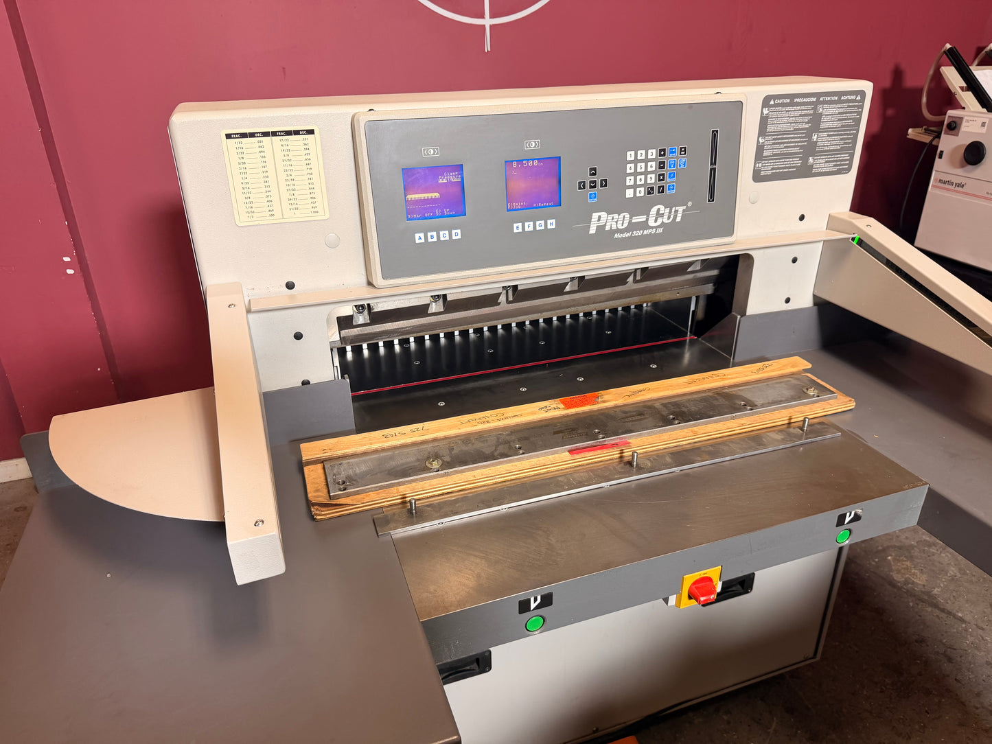 Used Pro-Cut 320 MPS III programmable paper cutter for sale showing cutting bed and clamp
