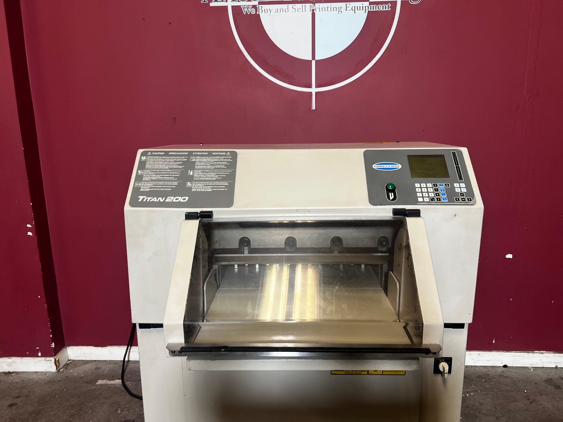 Used Challenge Titan 200 Hydraulic Paper Cutter with hydraulic clamp, sold by AA&D PressExchange.