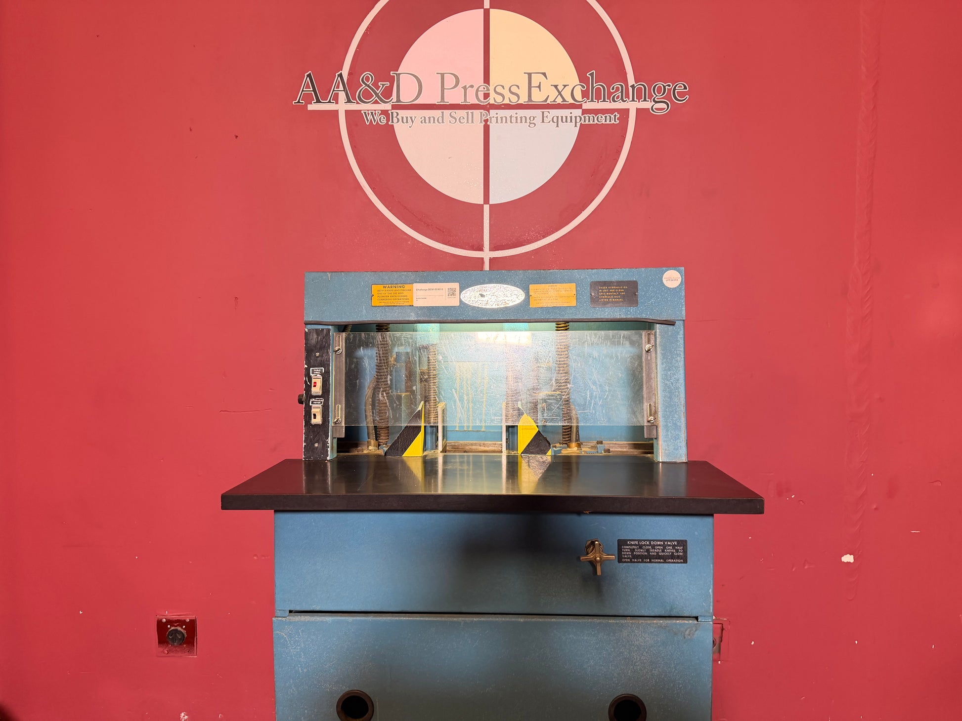 Used Challenge DCM Double Round Cornering Machine close up of cutting blades and paper alignment