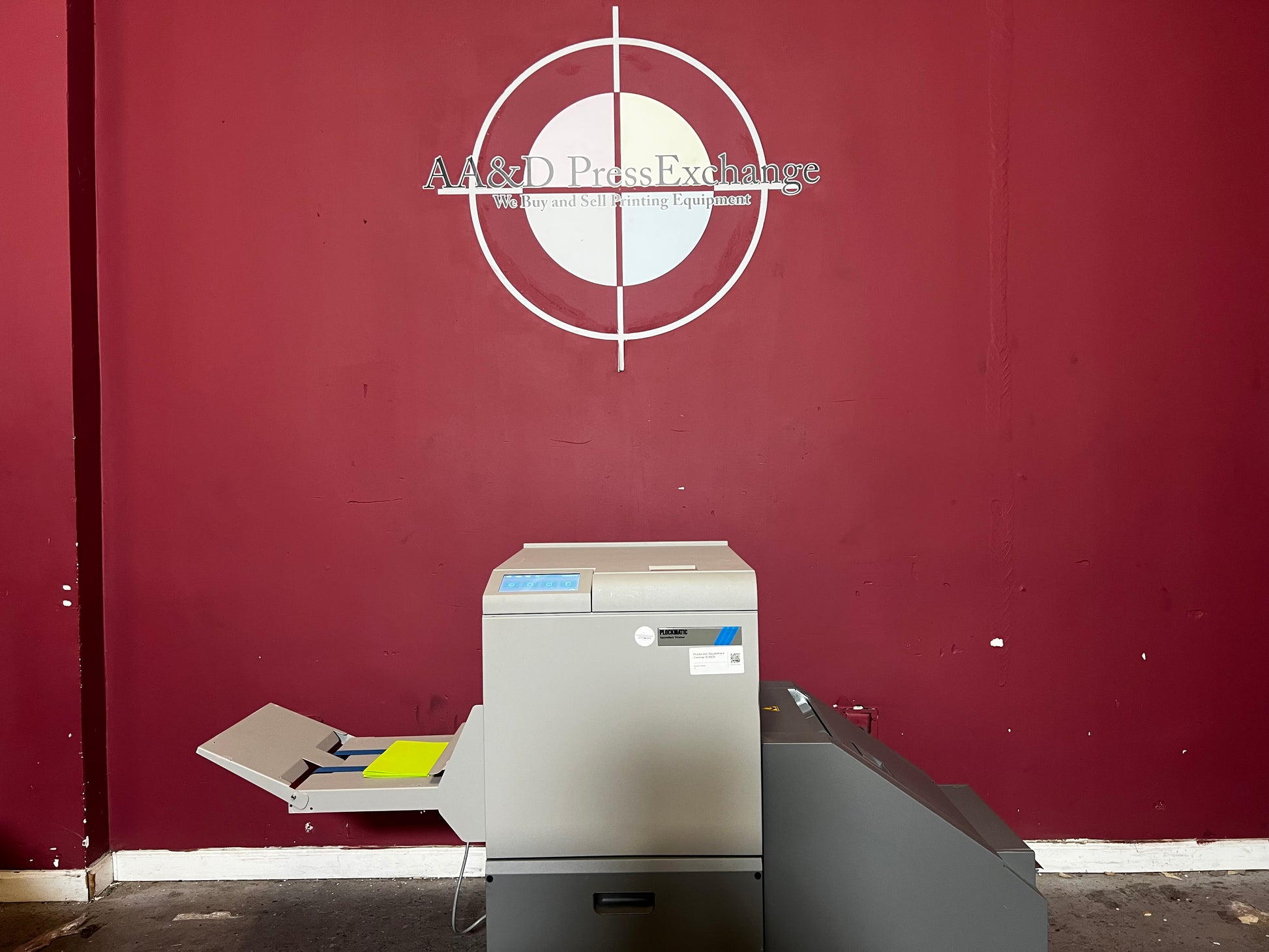 Used Plockmatic SquareBack Trimmer close-up of output booklet with square spine finish – AA&D PressExchange