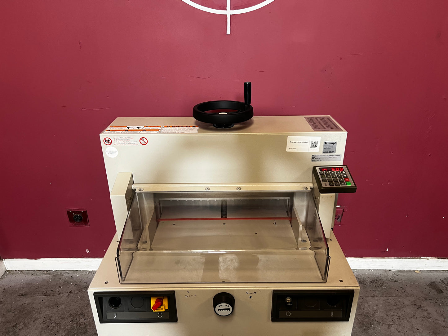 Used Triumph 4810-95EP guillotine paper cutter front view in print shop environment – AA&D PressExchange