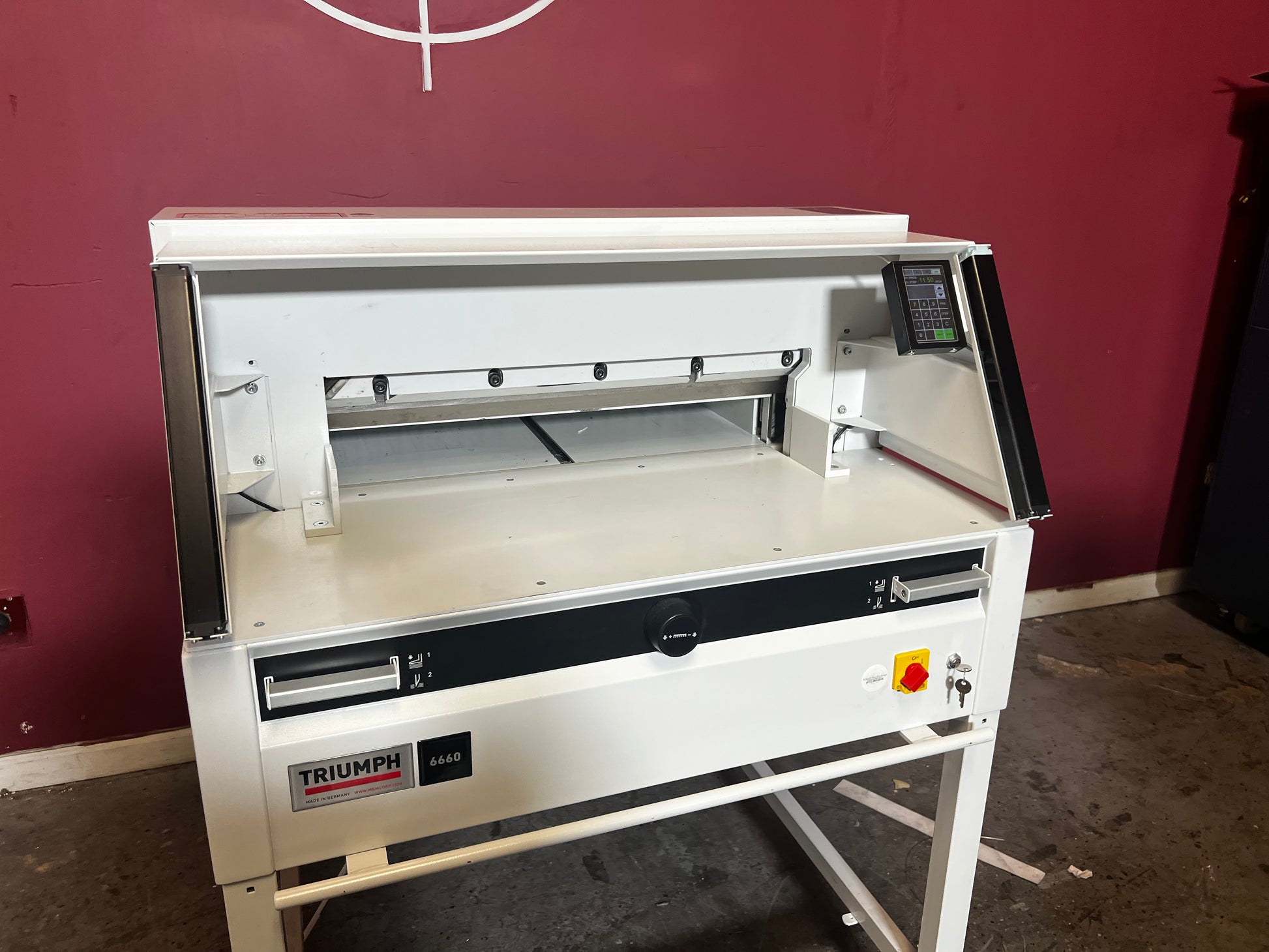 Used Triumph 6660 paper cutter side/rear view highlighting cutting mechanism – AA&D PressExchange