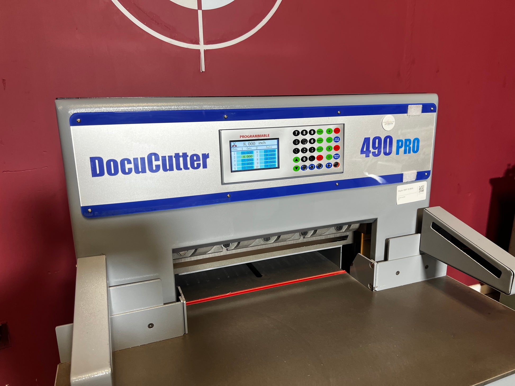 AA&D PressExchange Used Duplo 490 PRO hydraulic paper cutter close-up of foot pedal and operator controls