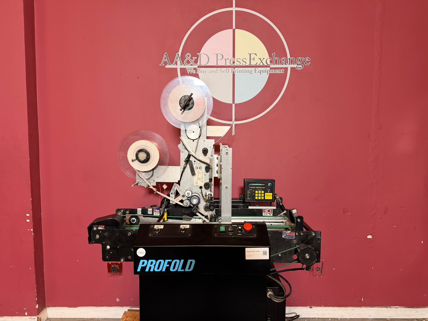 Used Profold tabbing machine tab placement rollers and mechanism for precise tab alignment
