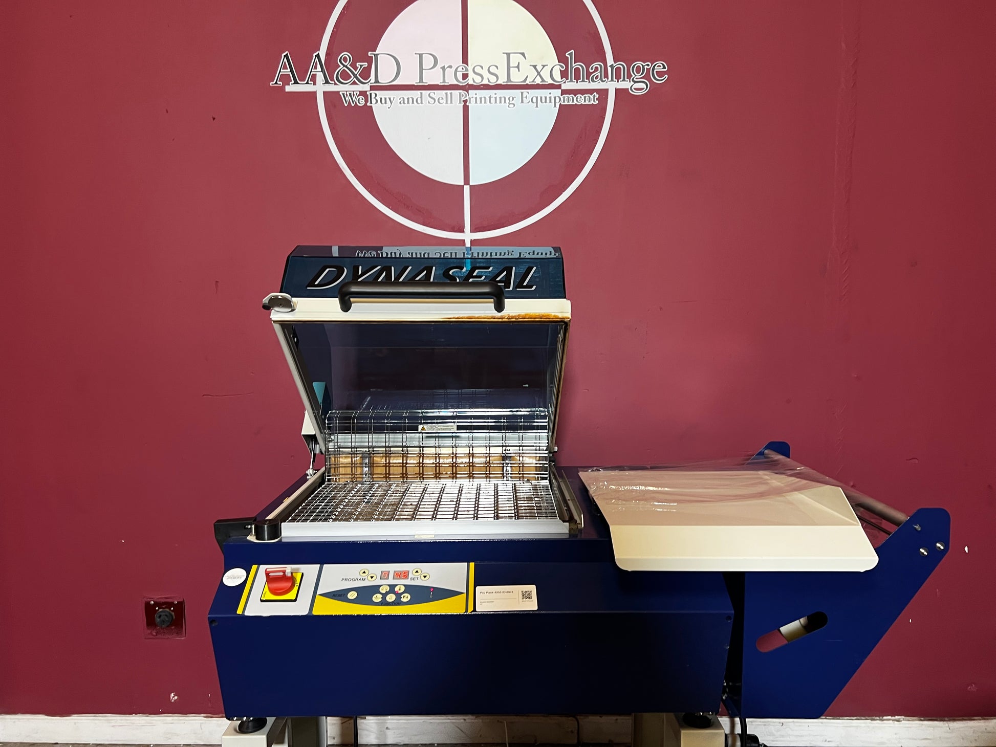 Used Dynaseal Shrink Wrapper close-up of machine conveyor and guides – AA&D PressExchange