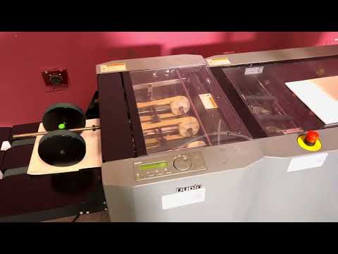 Used Duplo DBM-120 booklet maker with trimmer overview in professional booklet production workflow – AA&D PressExchange